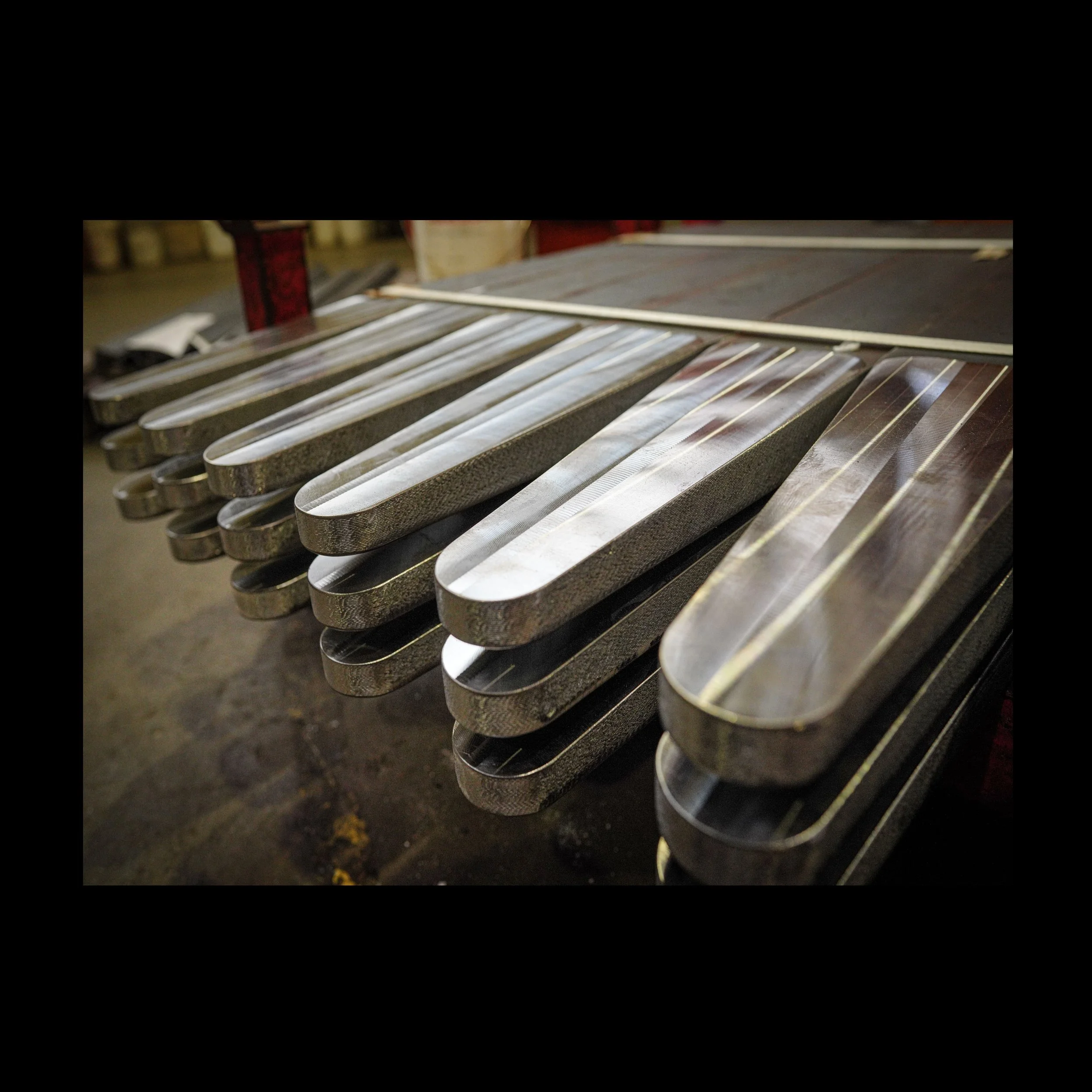 Milled tine styles for crane fork stacked on a pallet.