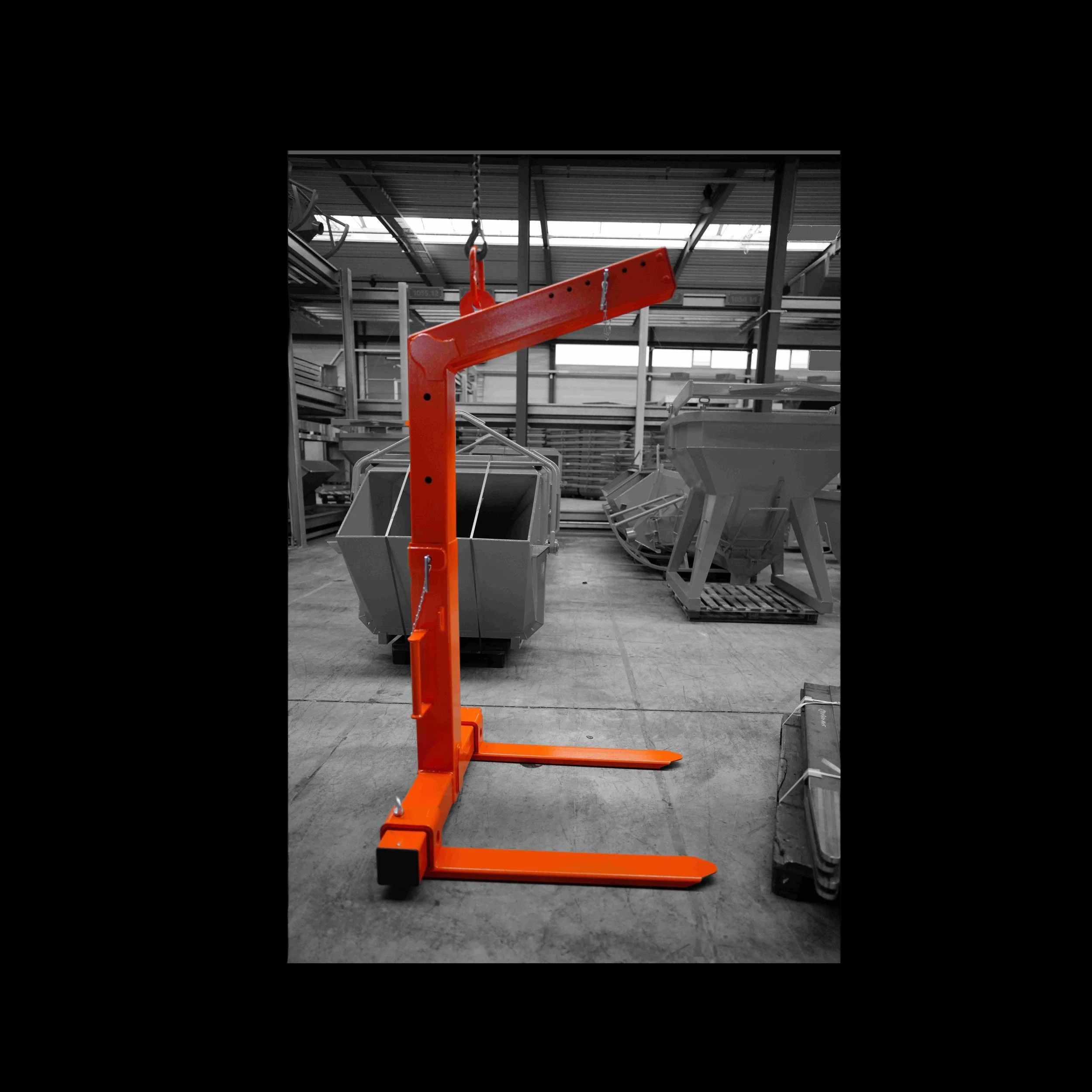 Crane forks that are self shifting in orange on a black and white background
