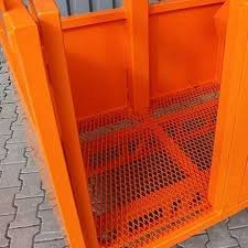 Crane Man Basket door for a two person basket. The steel product is orange in color with a gray brick background.