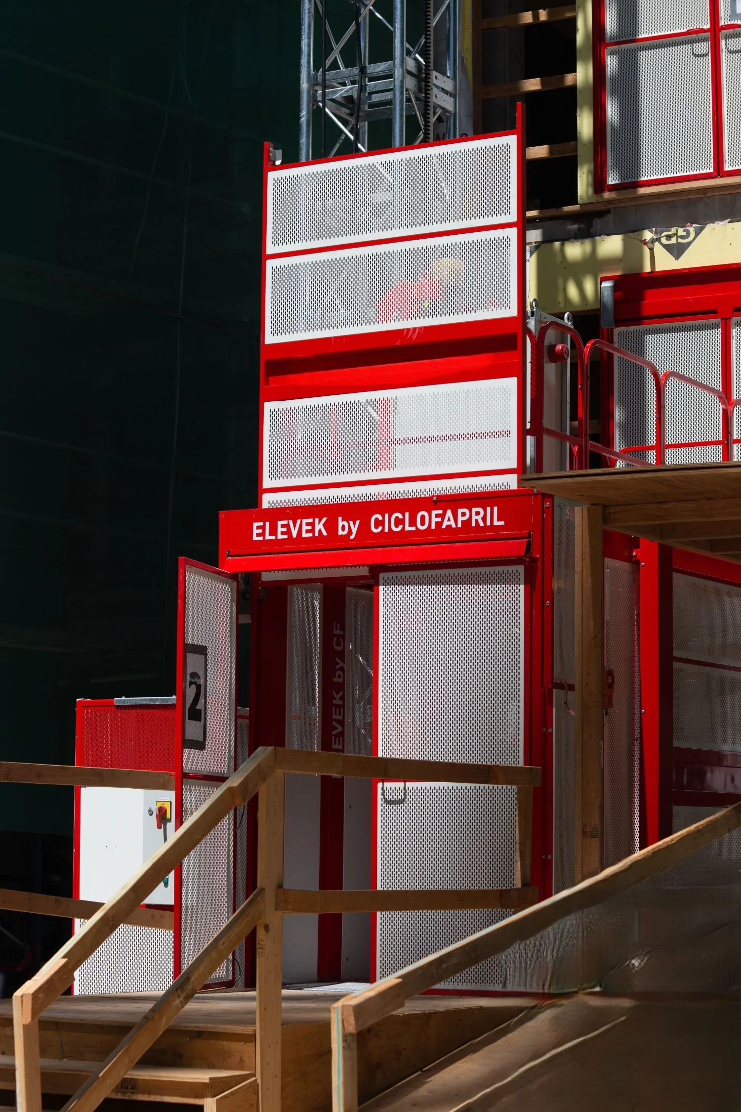 Hoist on a job site in red and white contrasting nicely