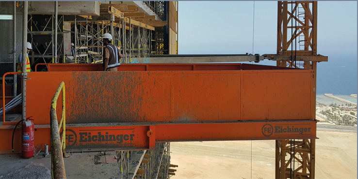 Retractable crane loading platform in use in the Middle East. This orange platform has some concrete on it because it's on an active construction site