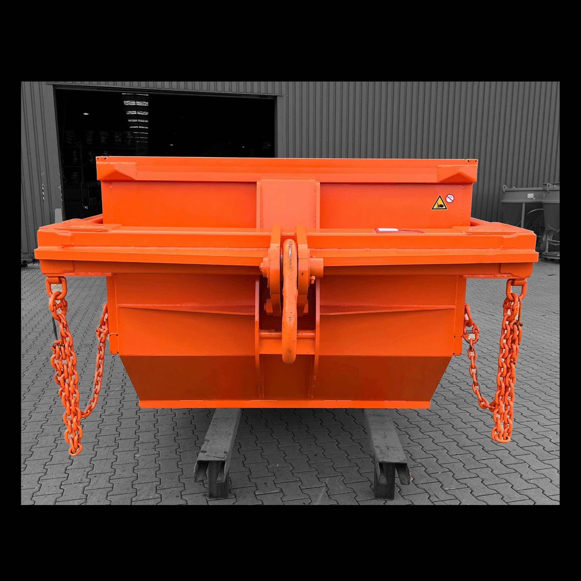 The orange attachment point of an Eichigner dump box used to move construction debris.