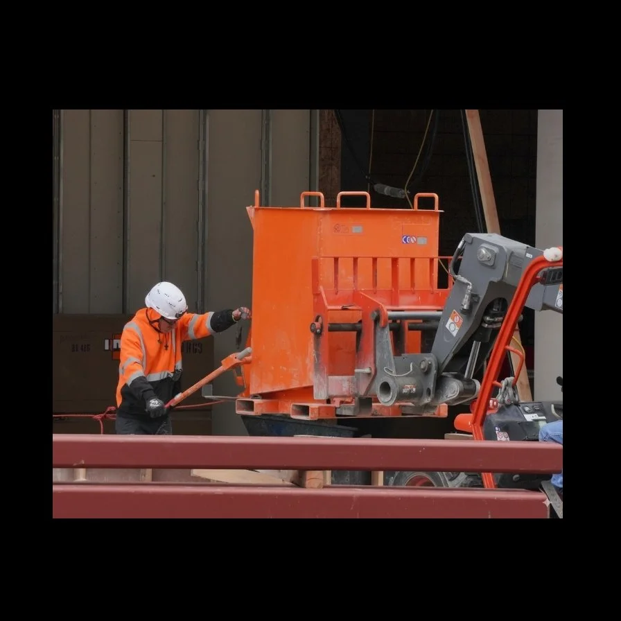 1.3 yard concrete bucket delivering concrete on a telehandler forklift on a construction jobsite.