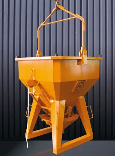 Eichinger 1034 concrete bucket in orange on a studio background comprised of gray corrugated metal walls.