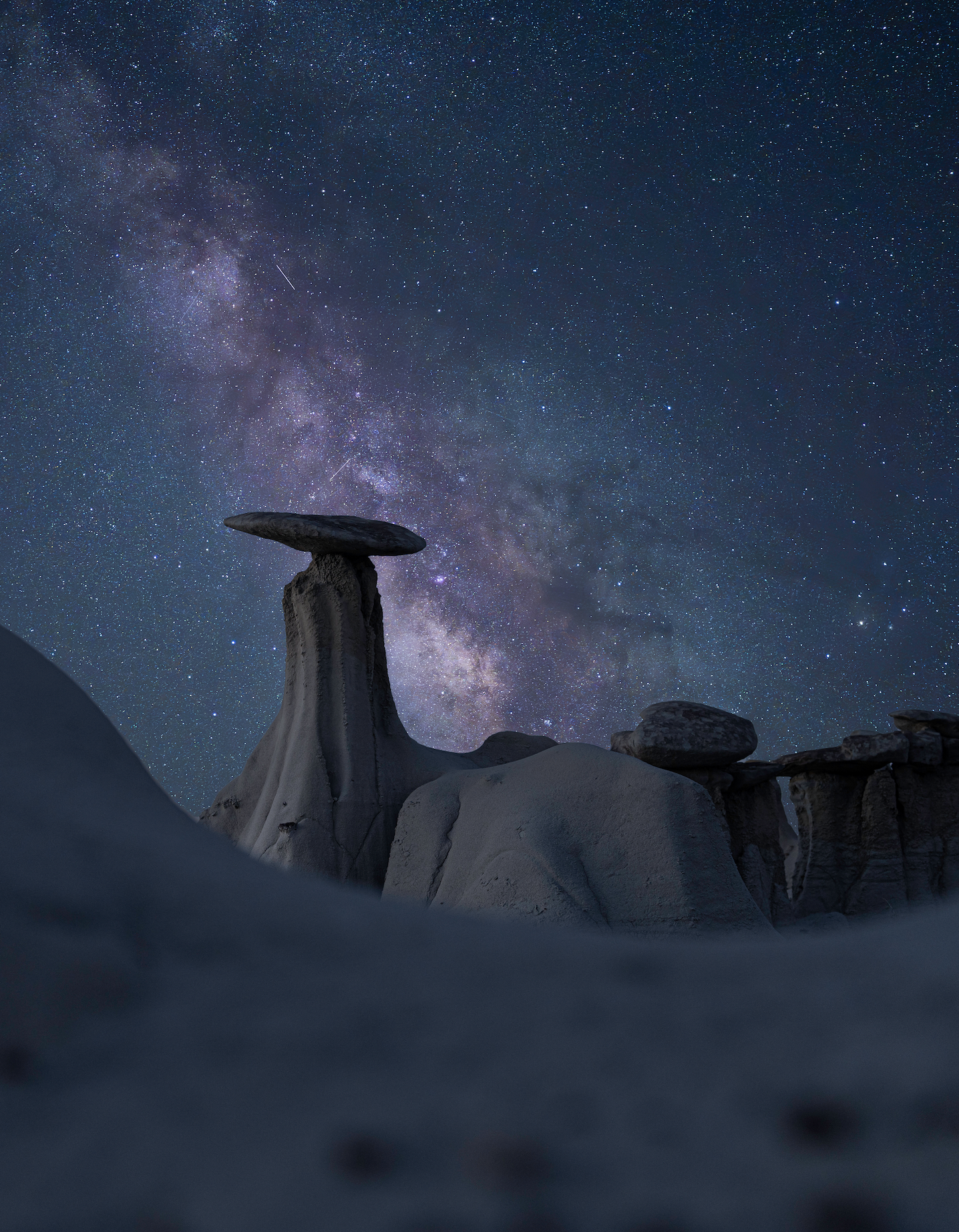Image of unique rocks in the evening with a Milkyway in the sky behind it