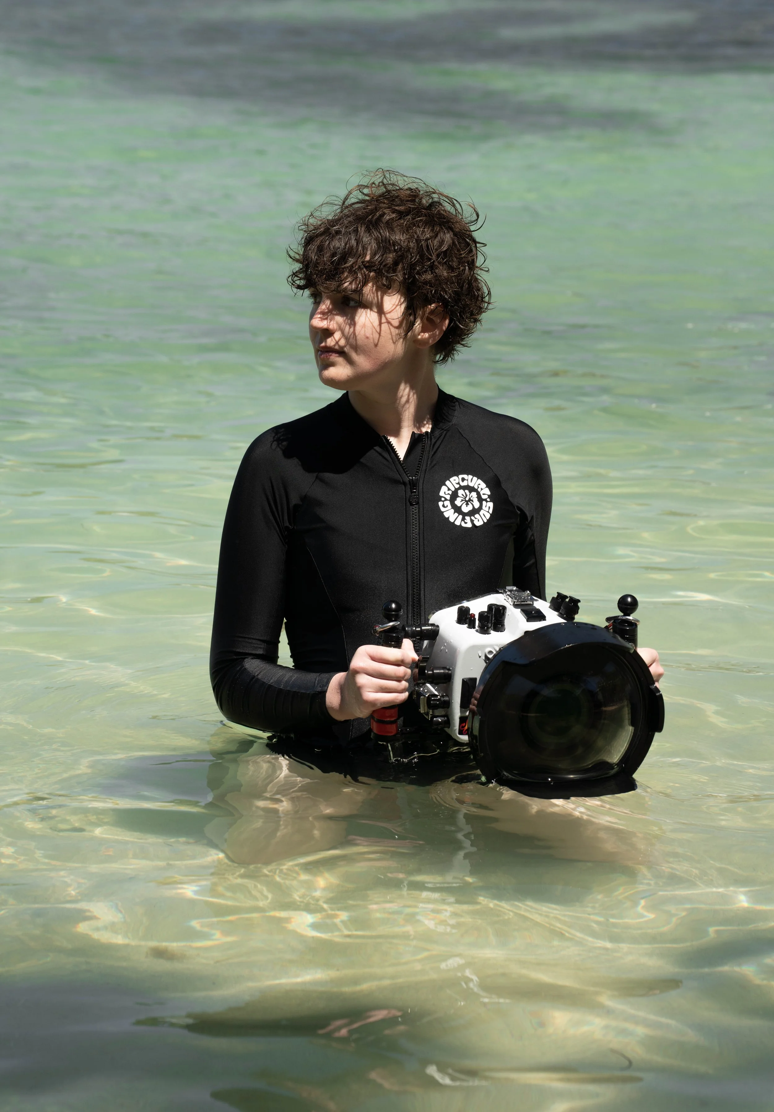 Sydney Smolla poses in the ocean with her Ikelite Underwater gear.