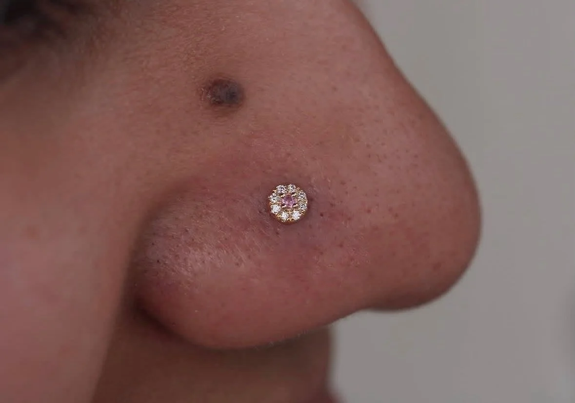 Genuine diamonds and pink sapphire set in 14k gold for this nose piercing done by @darby.pokes