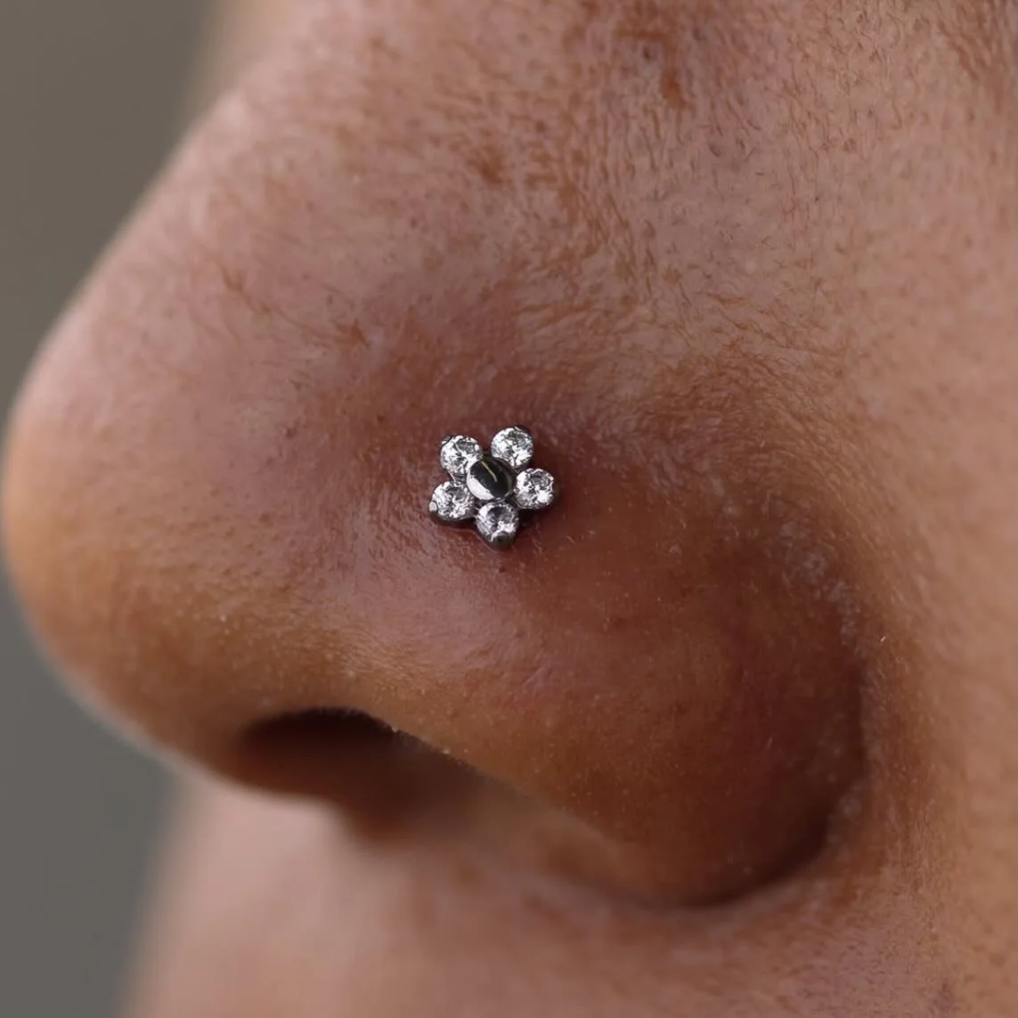 Titanium flower for this nostril piercing. done by our piercer @darby.pokes 
He has some walk-in availability today! come on in!
Or go to our website, ghostfiretattoo.com to schedule an appointment 
here 12-8 daily 
(318)-562-3021☎️