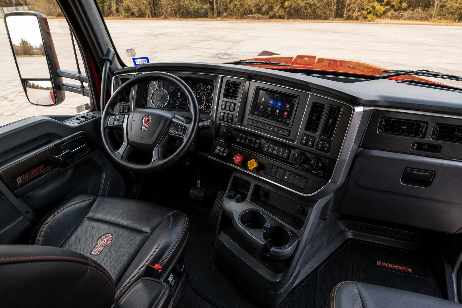 Interior of a semi-truck cab with a steering wheel, dashboard, and control panel.