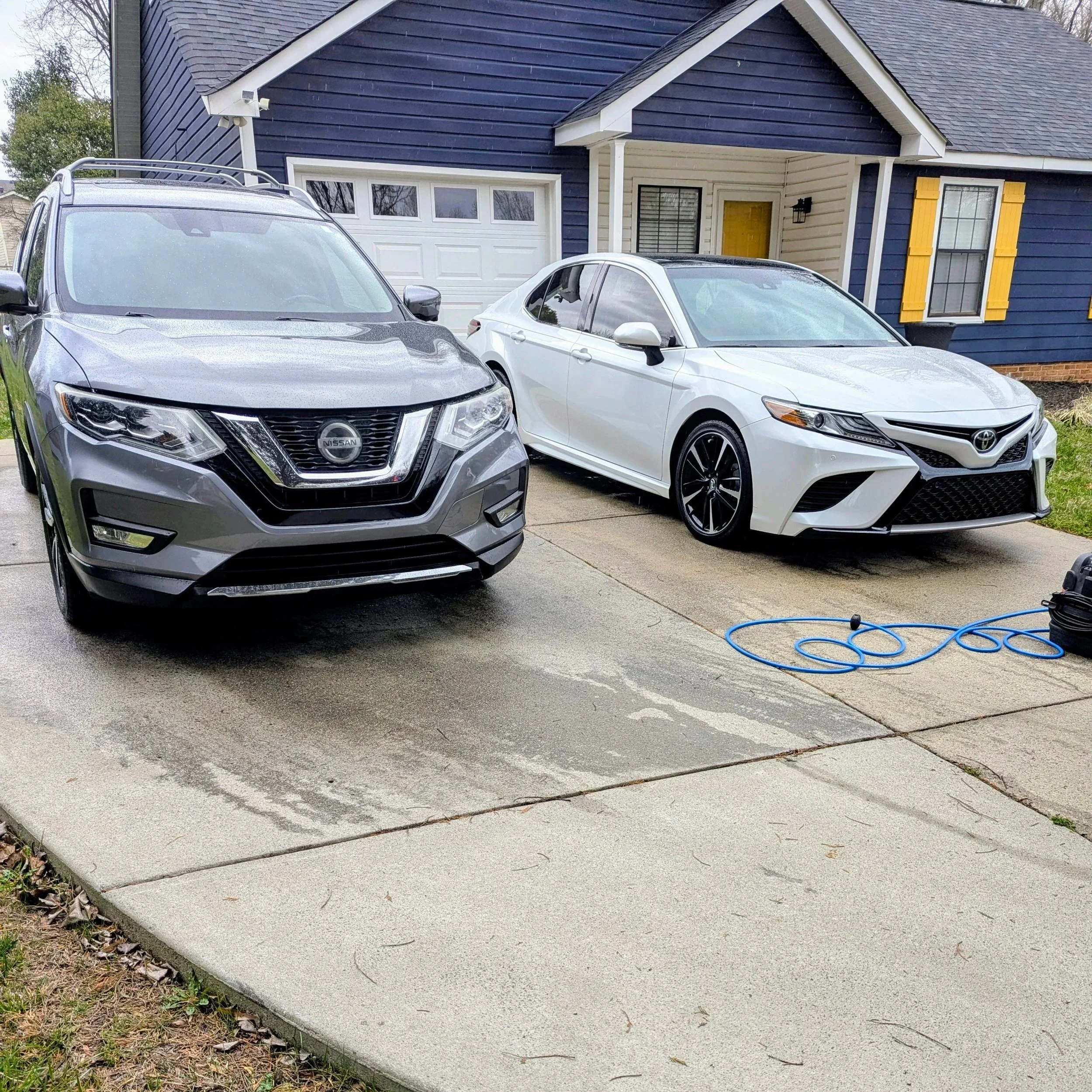 Two cars in a driveway