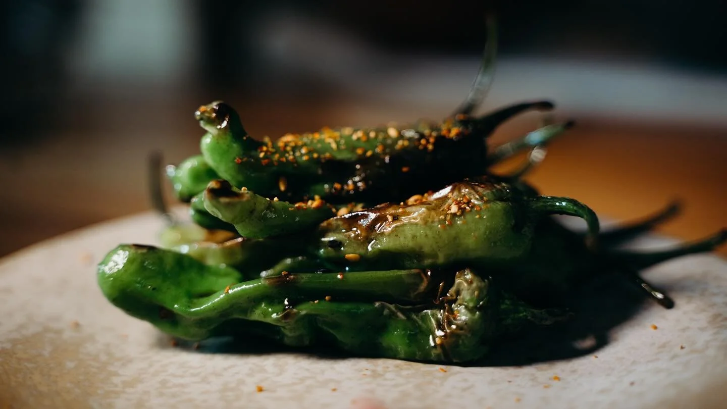 In season and on the menu now.
Grilled shishito peppers , onion soy , shichimi.