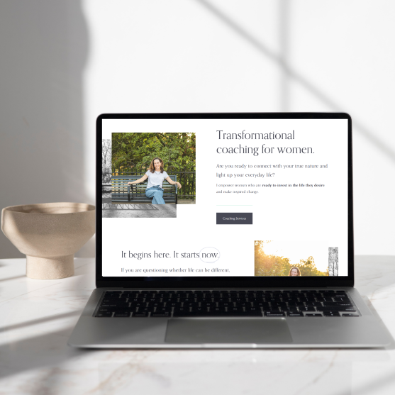 Laptop displaying a coaching website for women, featuring a woman sitting on a park bench surrounded by trees.