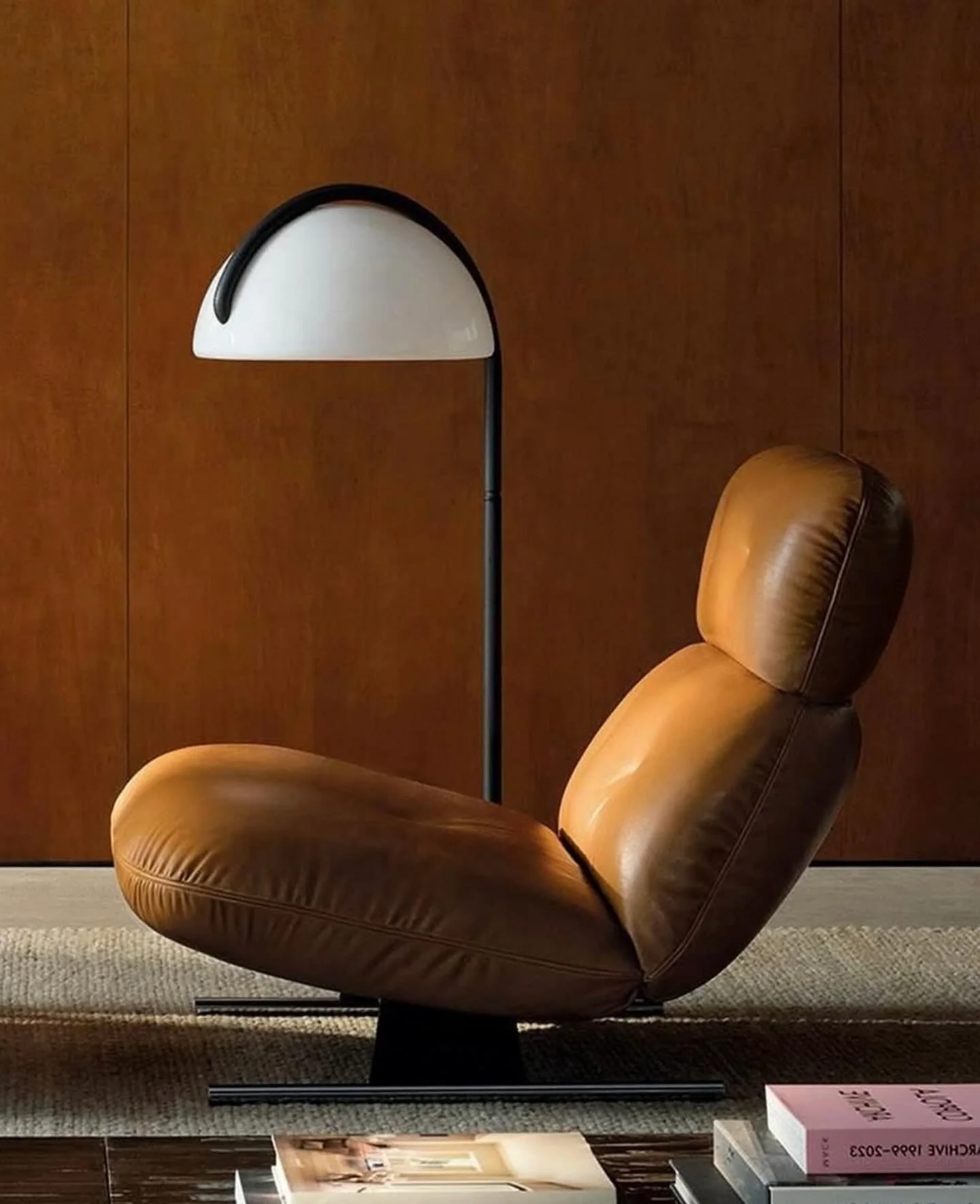 Minotti, Libra Armchair 

Inspired by 1970s aesthetics, the Libra armchair designed by Giampiero Tagliaferri is composed of overlapping soft volumes of the seat, backrest, and headrest, upholstered in leather or fabric, embellished with precise stitc