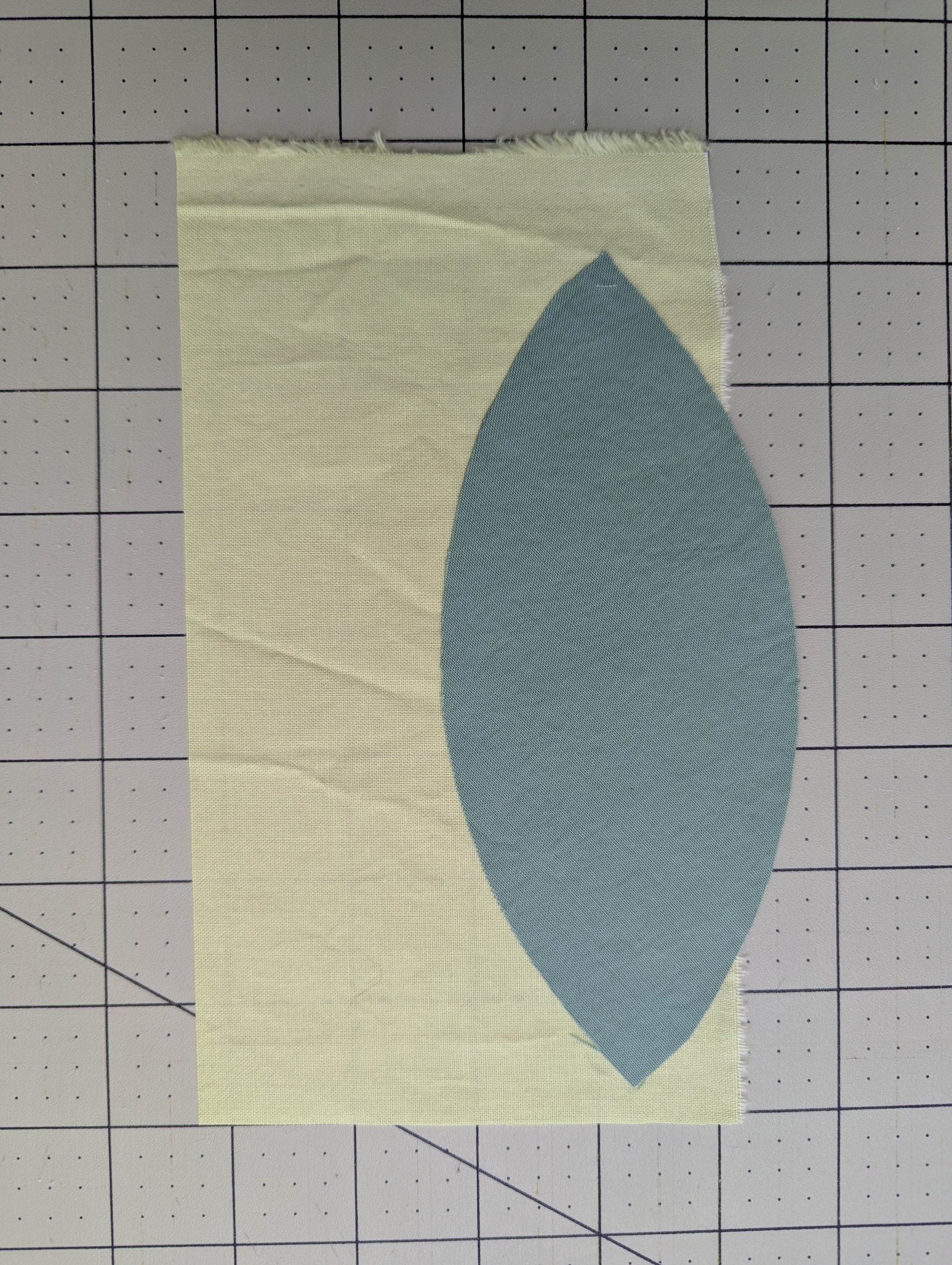 Green and yellow fabric being prepped to create an improv curved piece