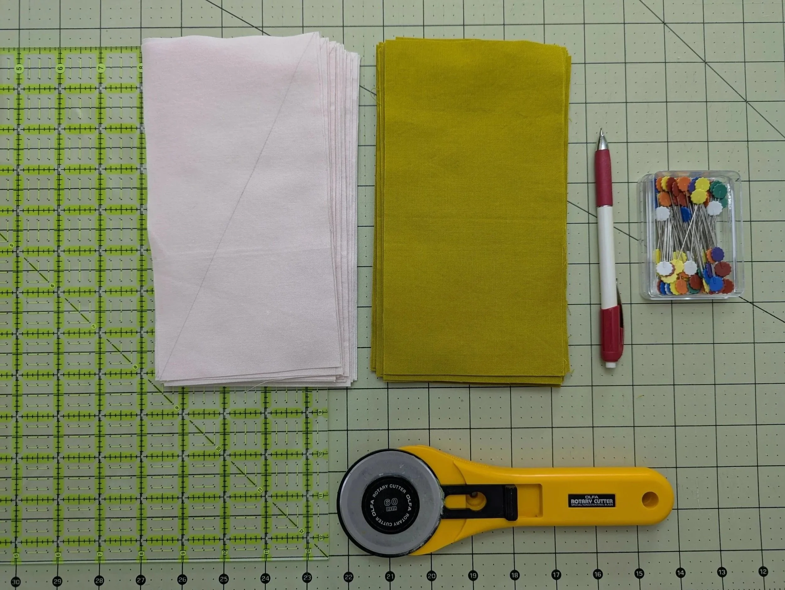 Materials prepped to make HRTs: fabric, pins, rotary cutter, marking pencil, ruler