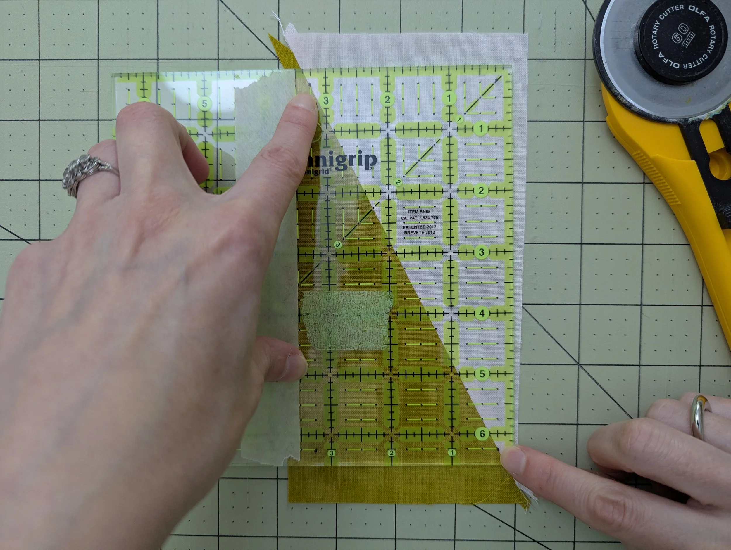 Fabric being measured with a ruler on a cutting mat
