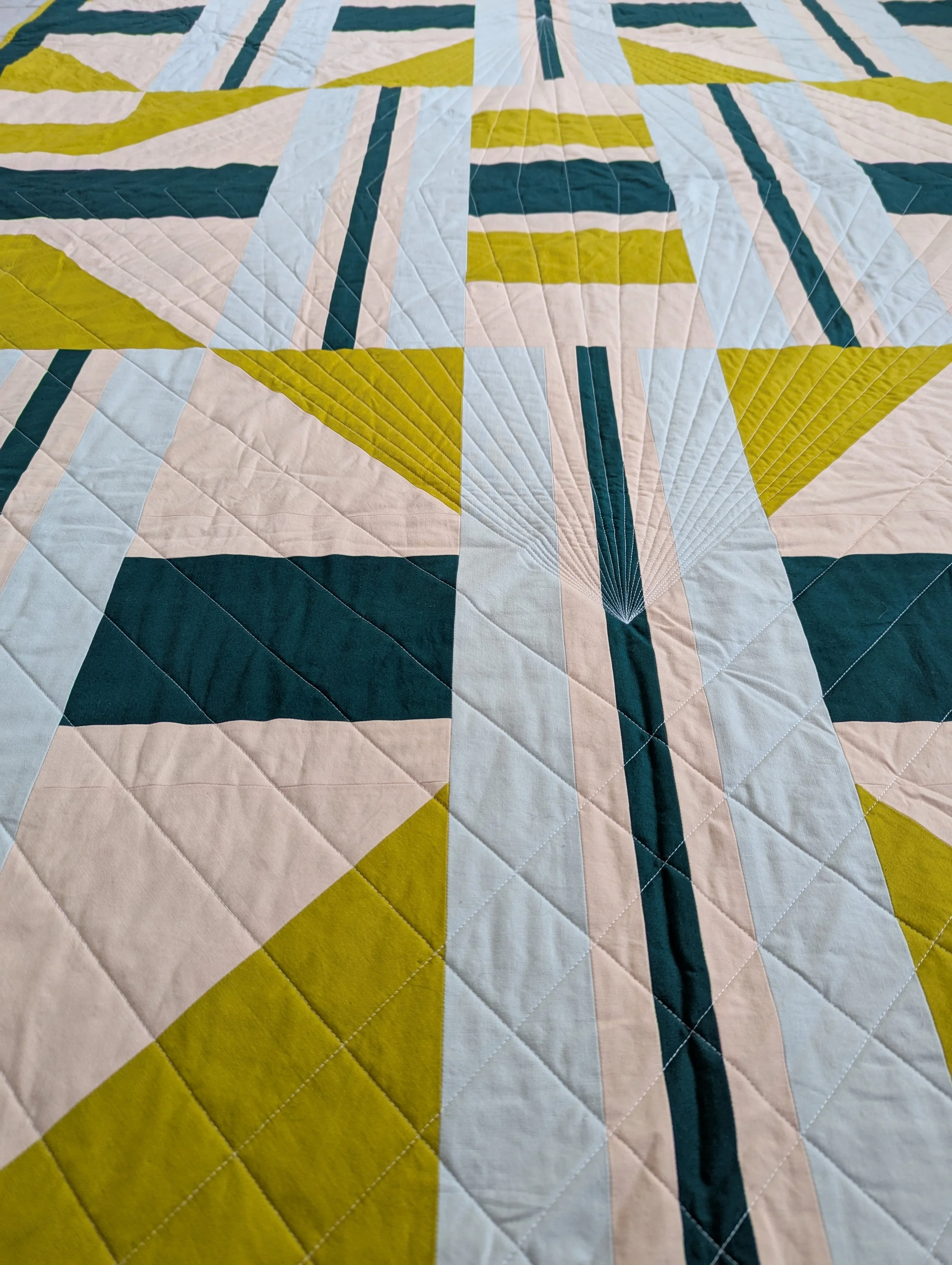 Close up of The 3895 Quilt by Millie & Bun Designs in green and pink colors
