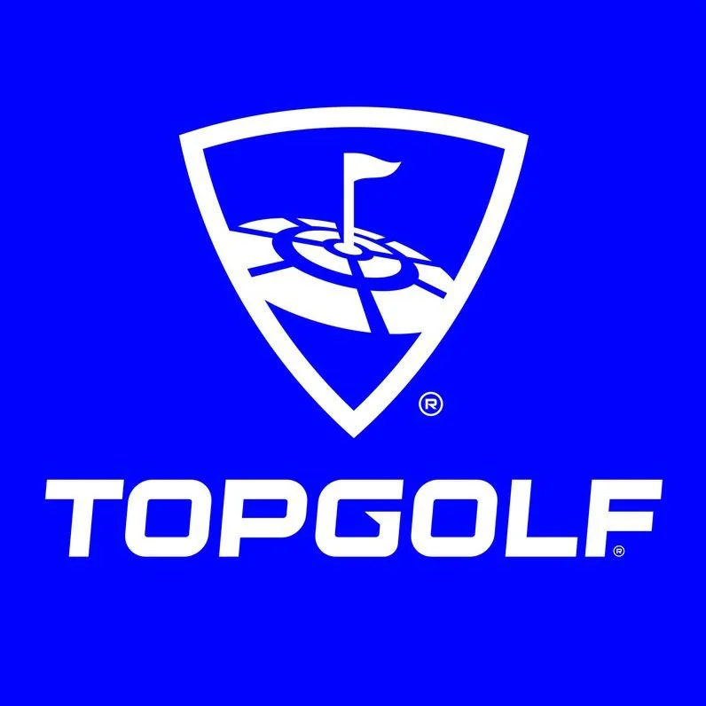 Topgolf logo with a shield emblem containing a flag on a golf hole, and the word 'TOPGOLF' written below in white against a blue background.
