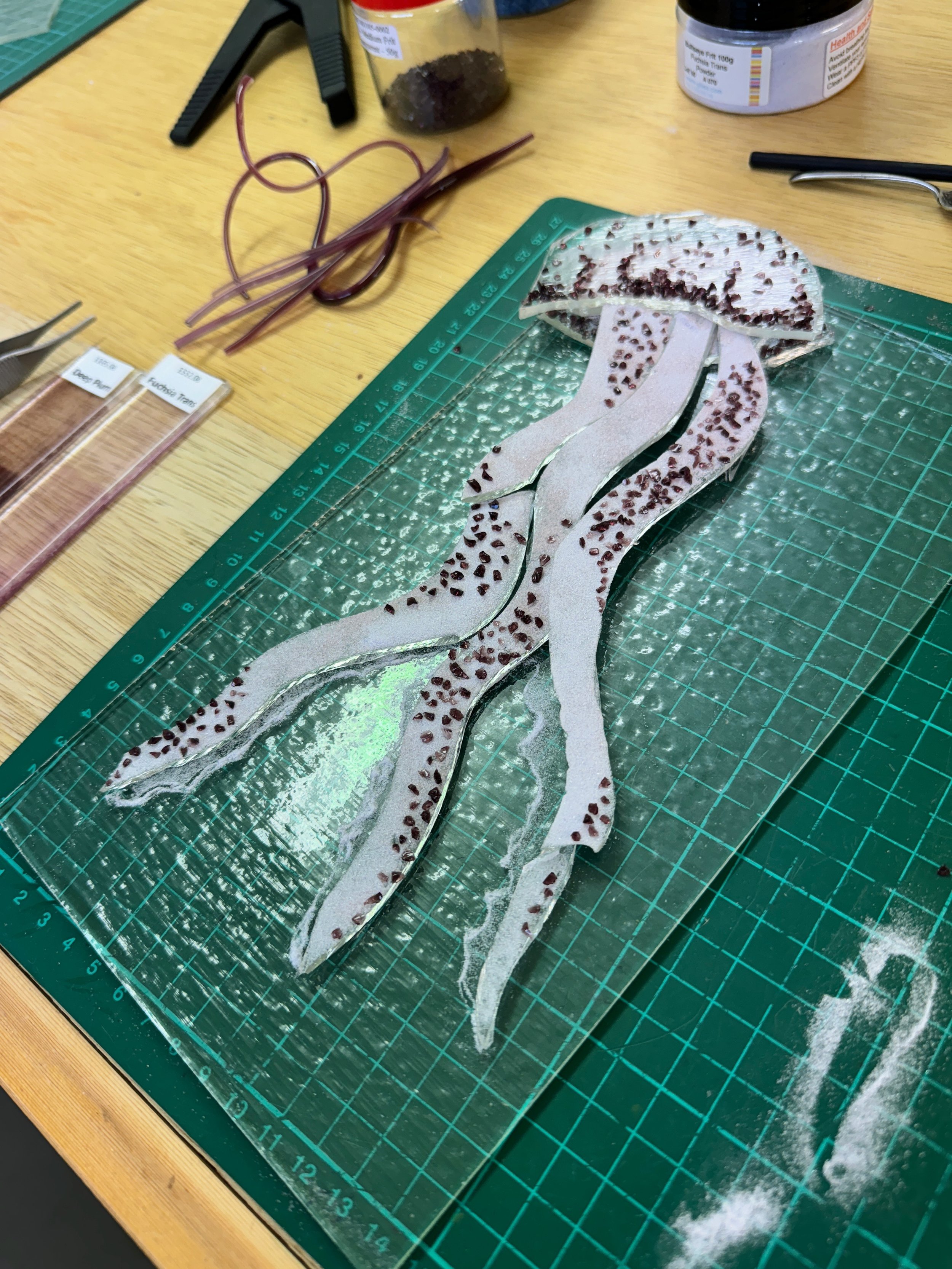 Glass jellyfish art piece on cutting mat