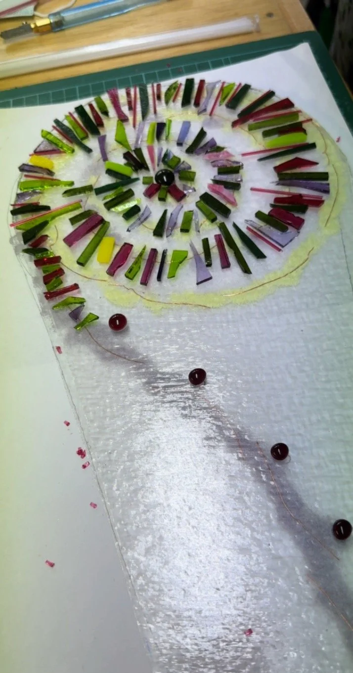 Colorful mosaic spiral design with glass pieces