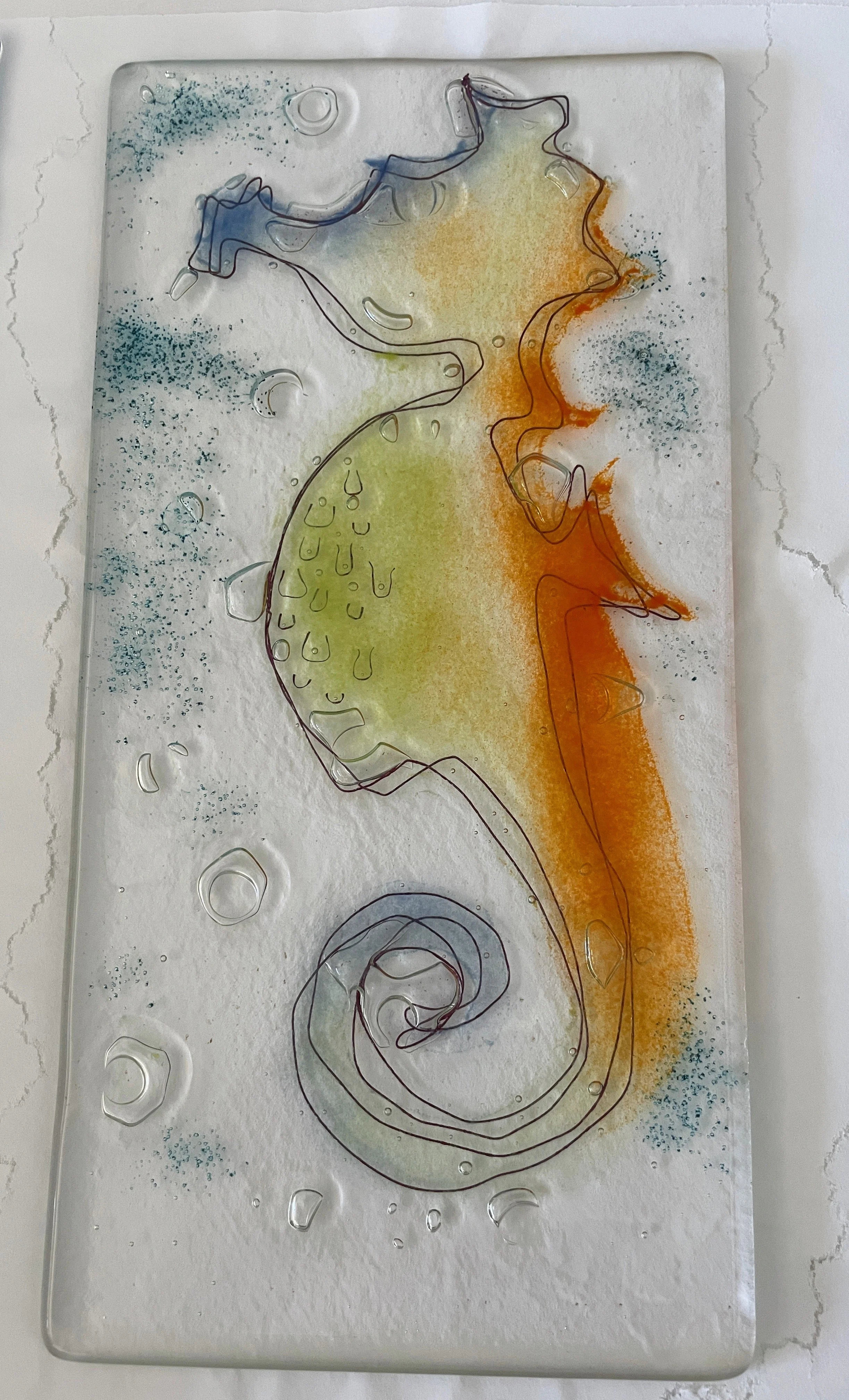 Colorful seahorse design on a textured glass panel with blue, green, and orange hues, featuring bubble patterns and an artistic outline.
