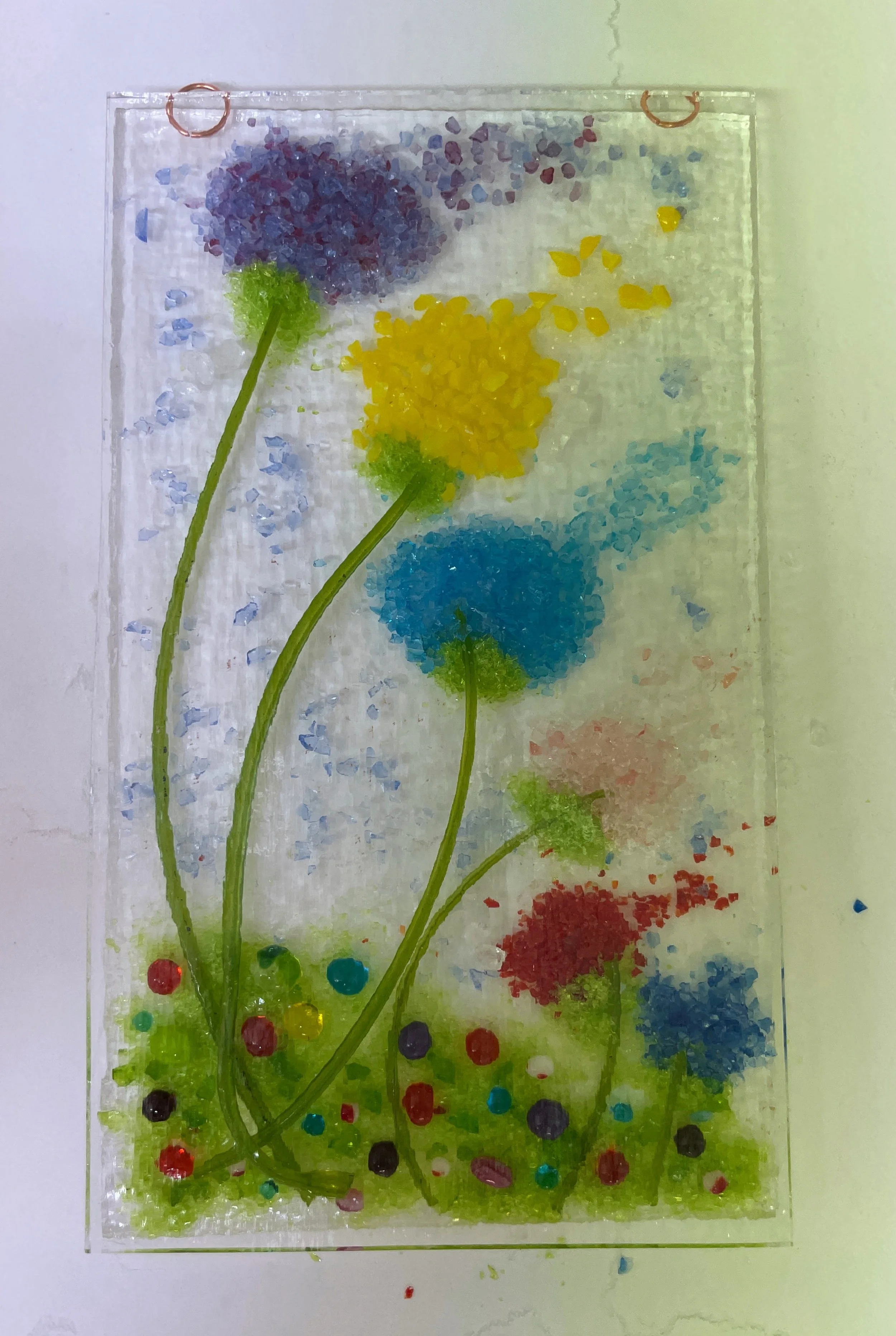 Colorful abstract floral artwork with blue, yellow, red, and purple textured flowers on a vertical panel.