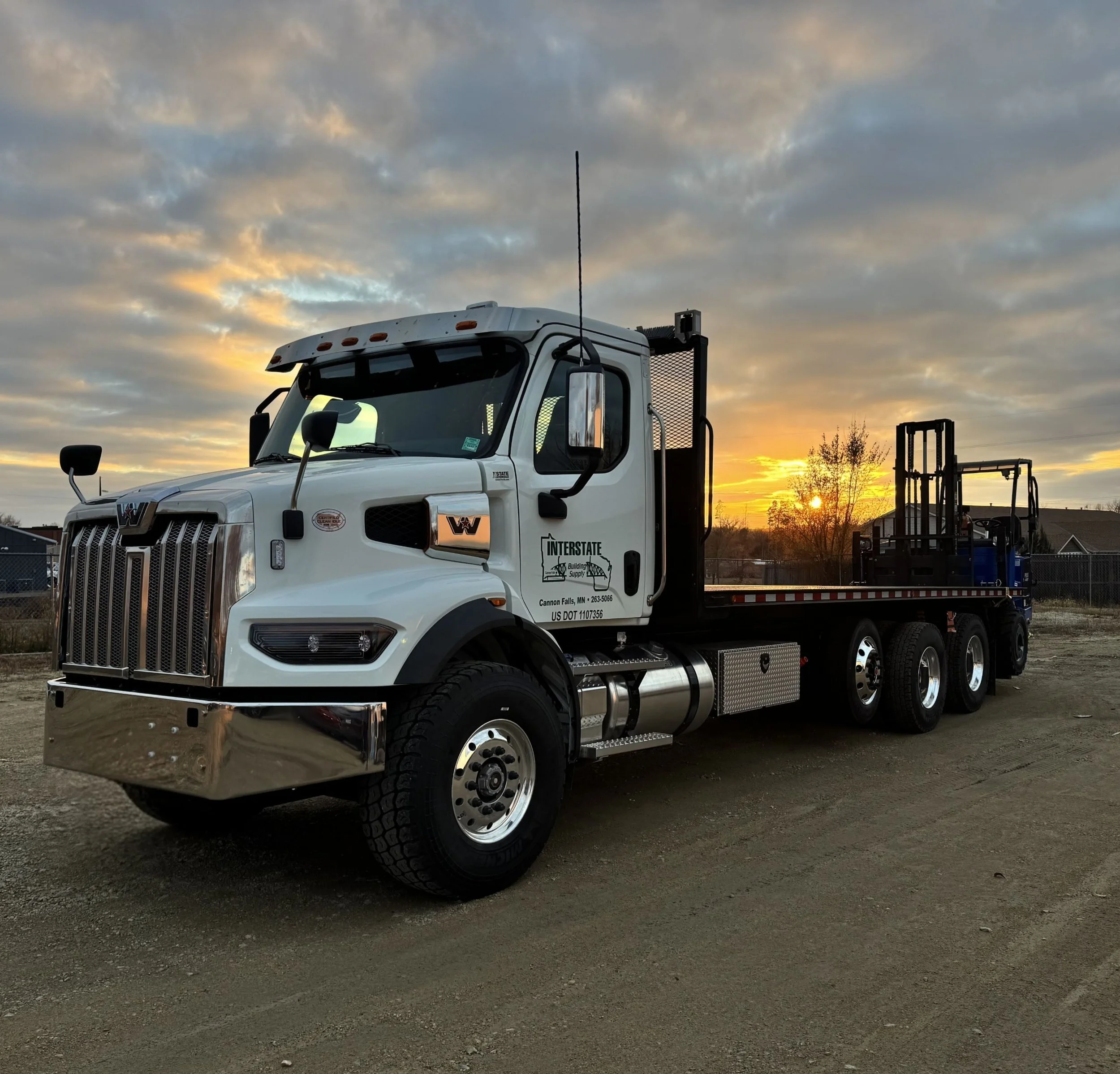 An Interstate Building Supply delivery truck with a mounted forklift, providing job-site support and premium lumber throughout Southeast Minnesota and the St. Croix Valley region.