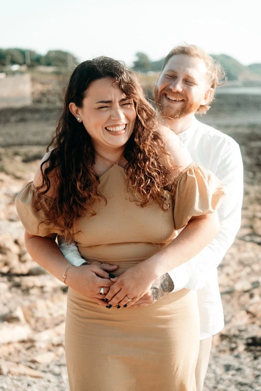 A happy couple outdoors, embracing each other and smiling
