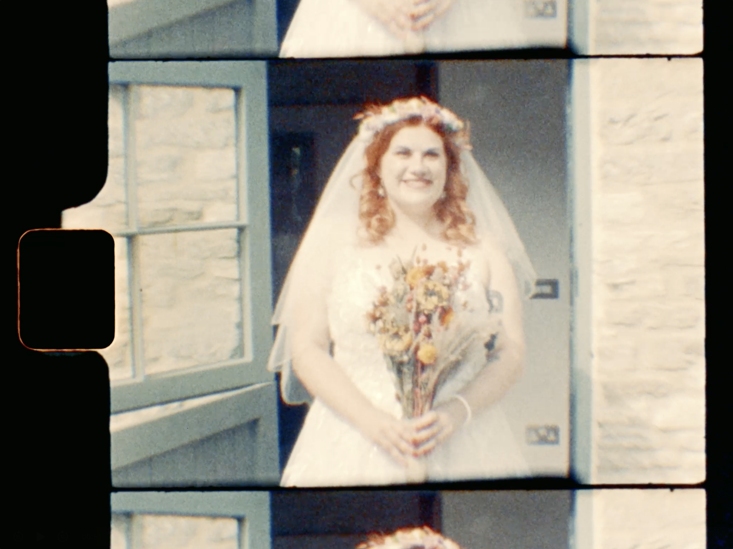 super 8 wedding film snippet of a bristol wedding - a bride smiles with her flowers in hand on Kodak film - 1970s analog camera footage