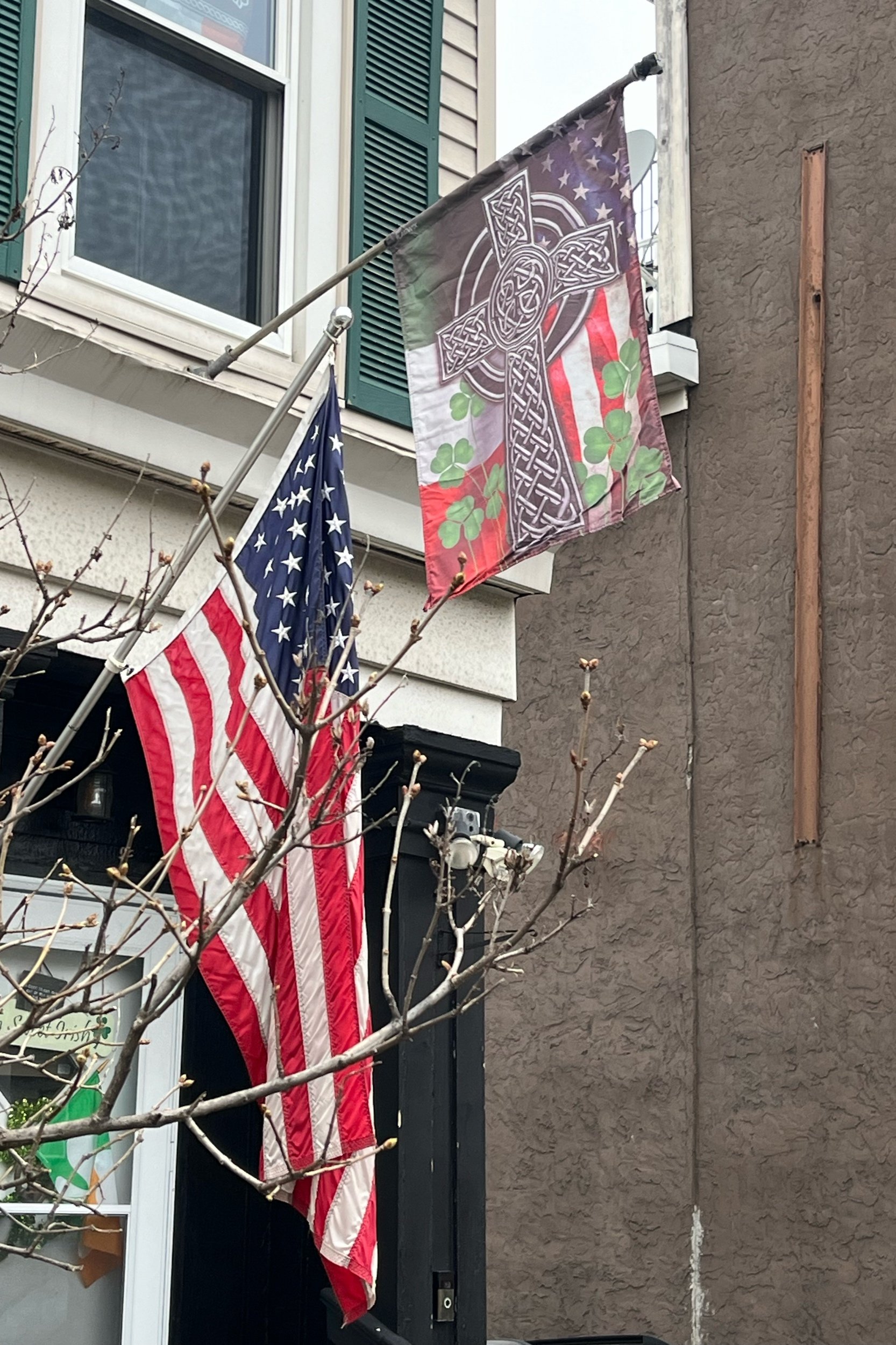 Flags outside a home in Southie on St. Patrick's Day 2023