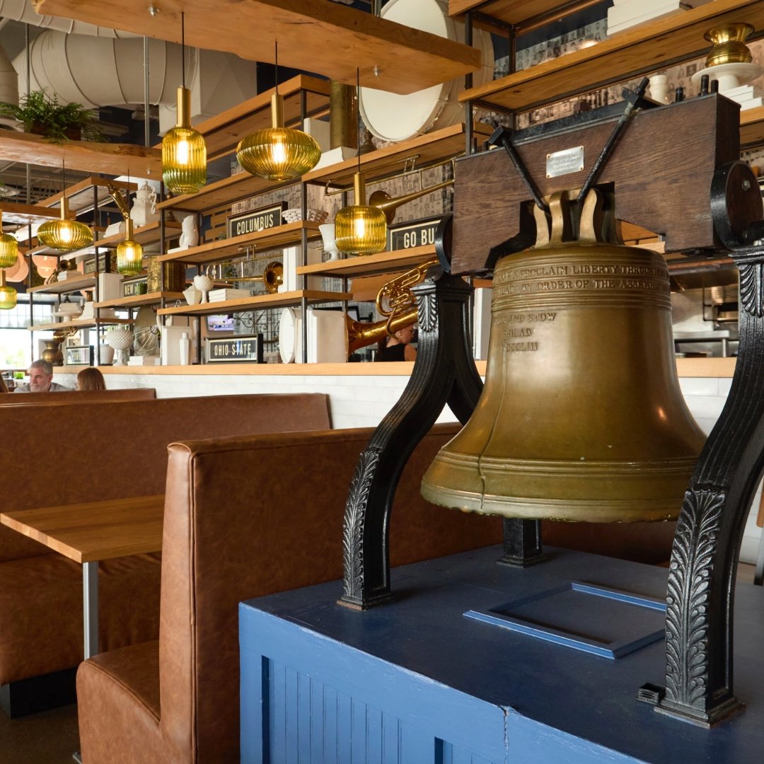 Liberty Tavern dining room with leather booths, warm wood finishes, and signature decor, creating an inviting neighborhood tavern setting in Polaris.