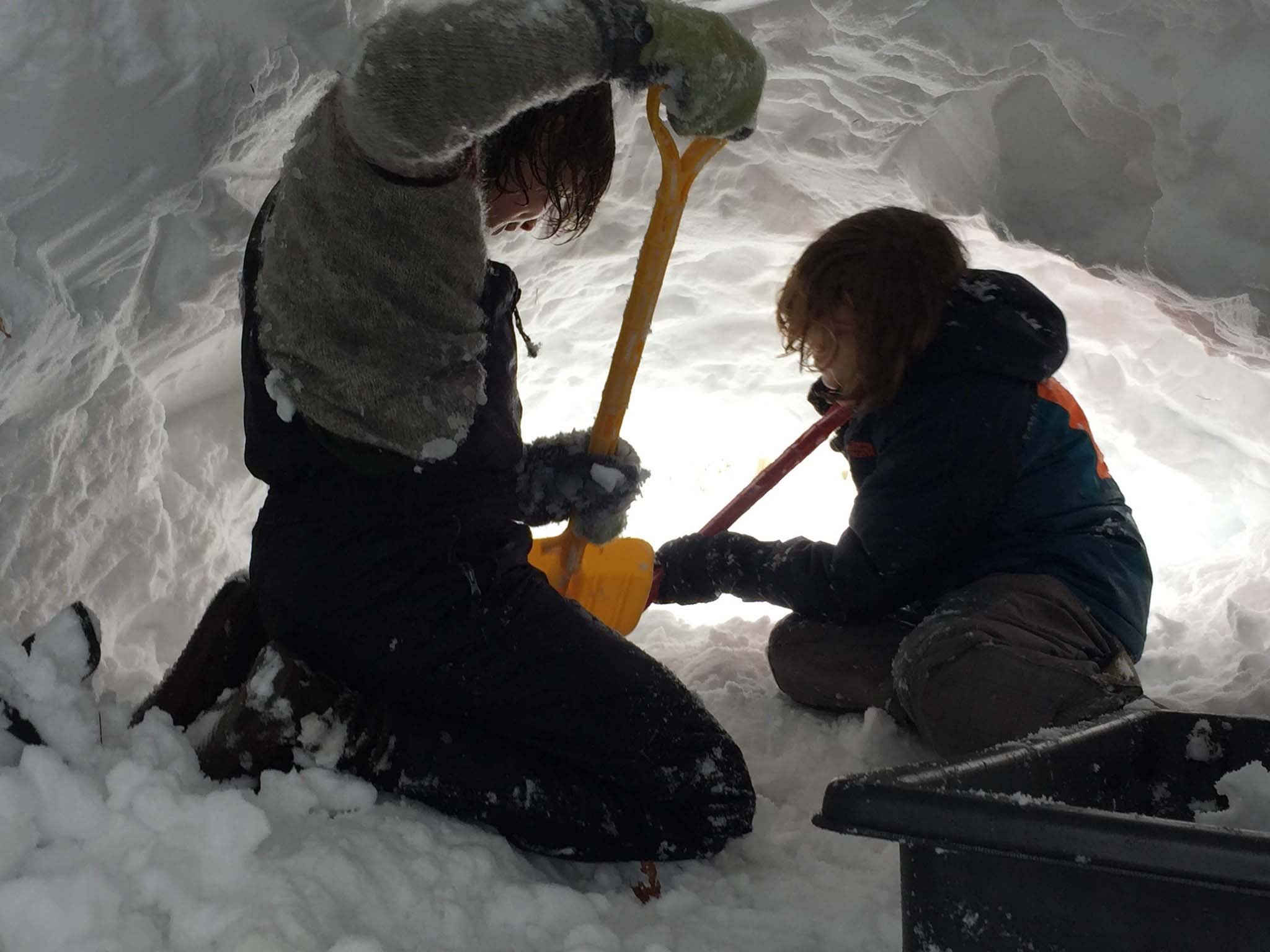 winter survival skills class digging in snow