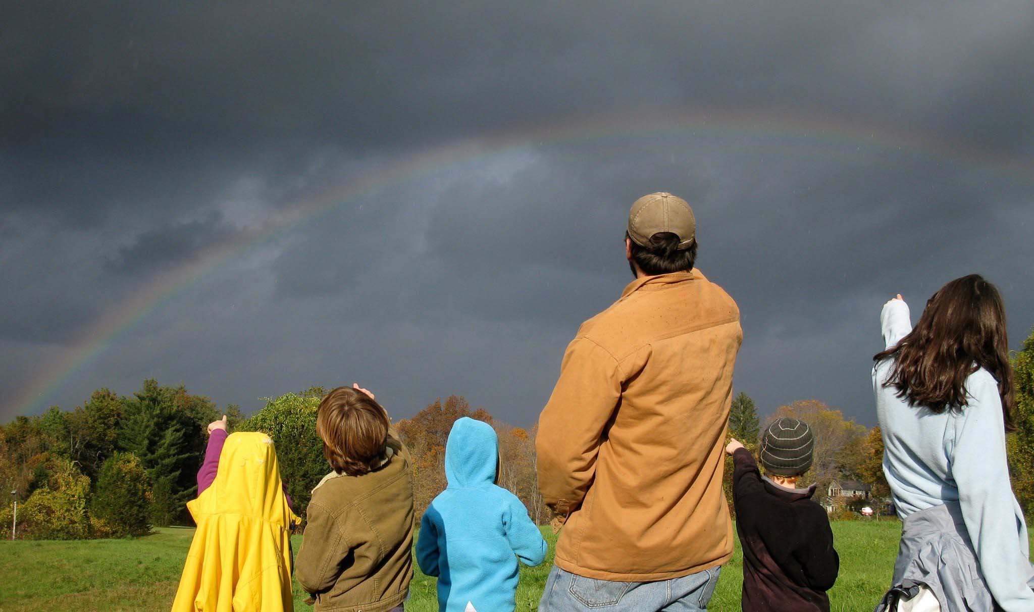 kids look at rainbow with outdoor summer camp counselor in Montague MA