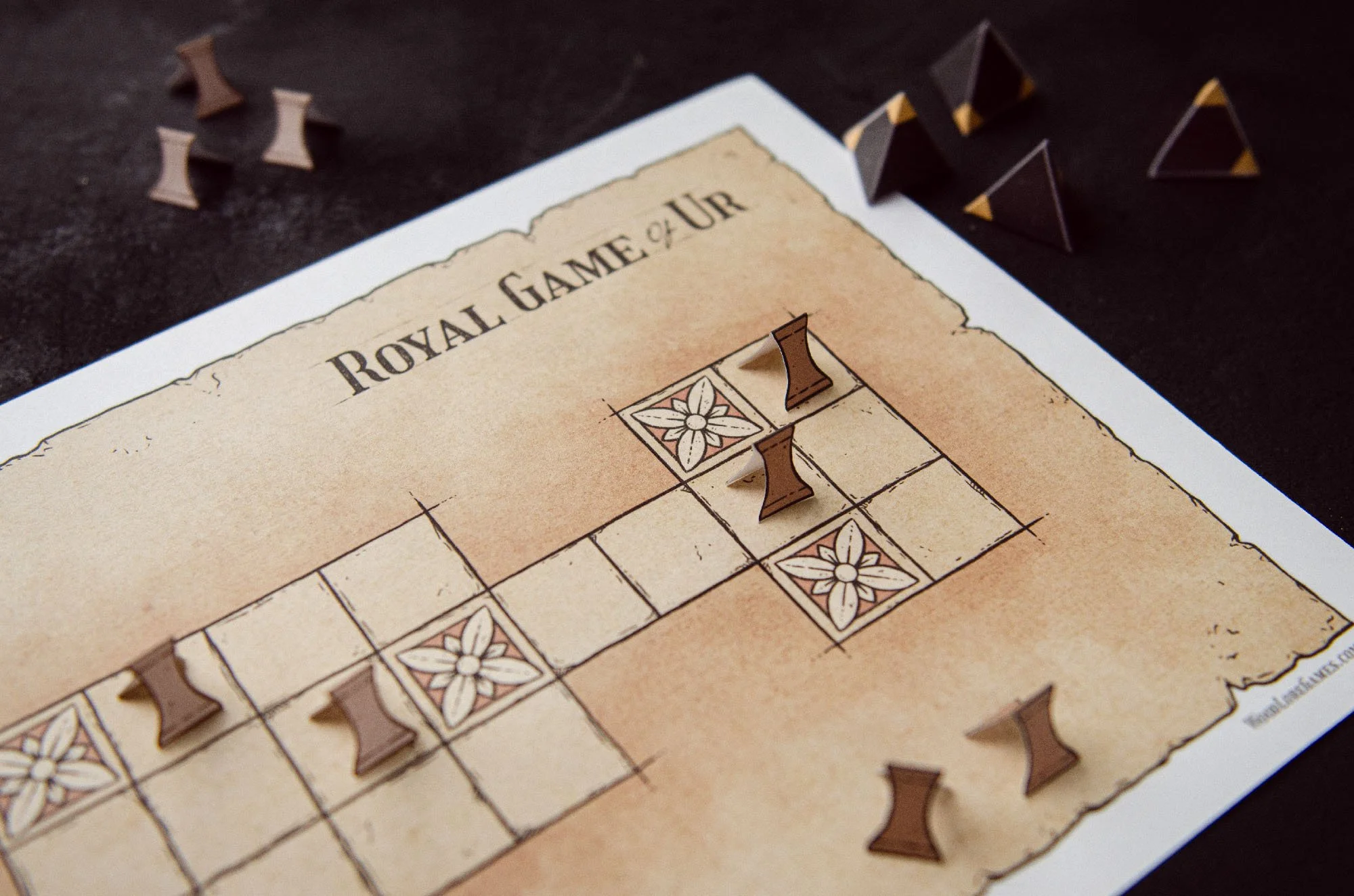 Printable Royal Game of Ur board with paper game pieces set up for play.
