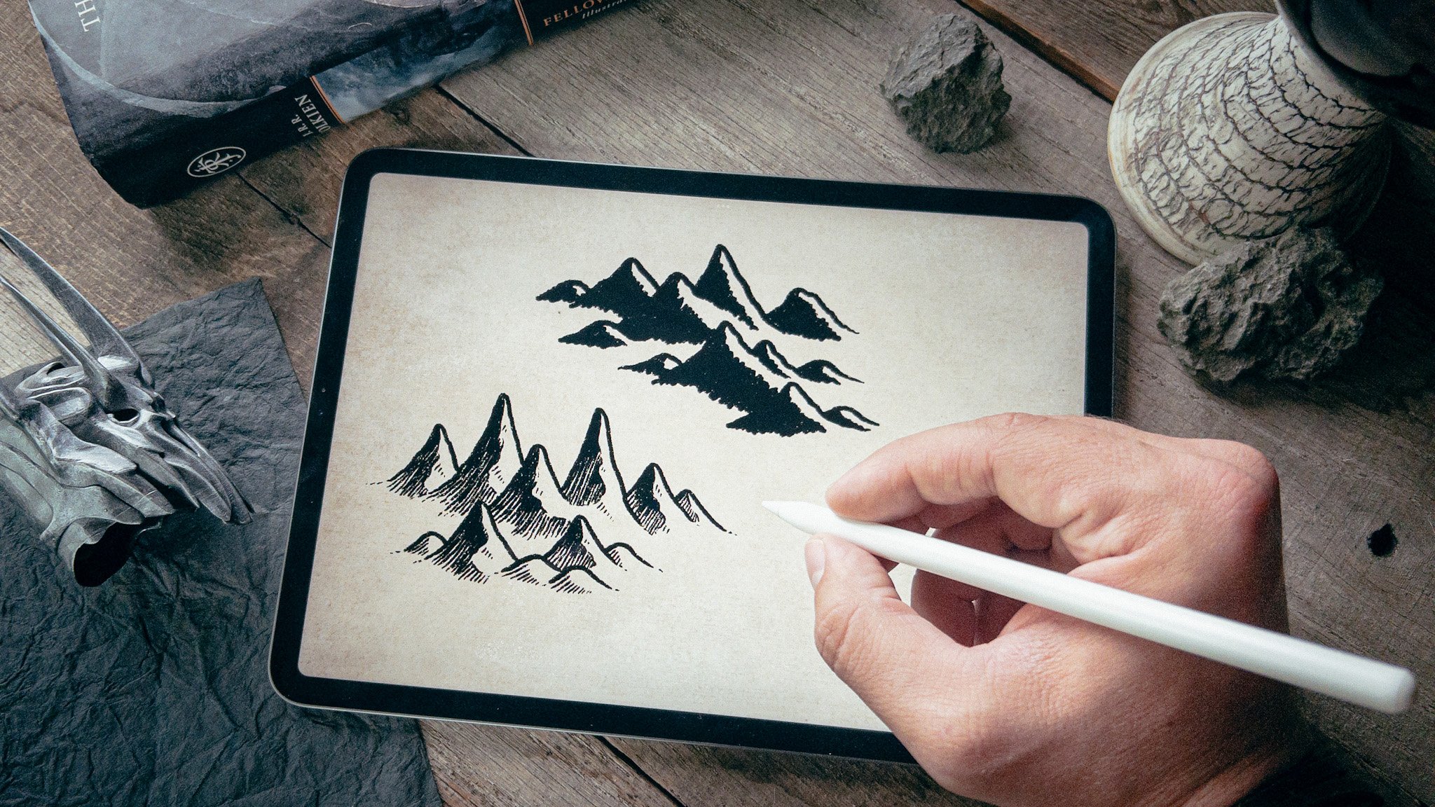 Hand drawn fantasy mountain range with snowy peaks illustrating a mountain drawing tutorial for fantasy maps.