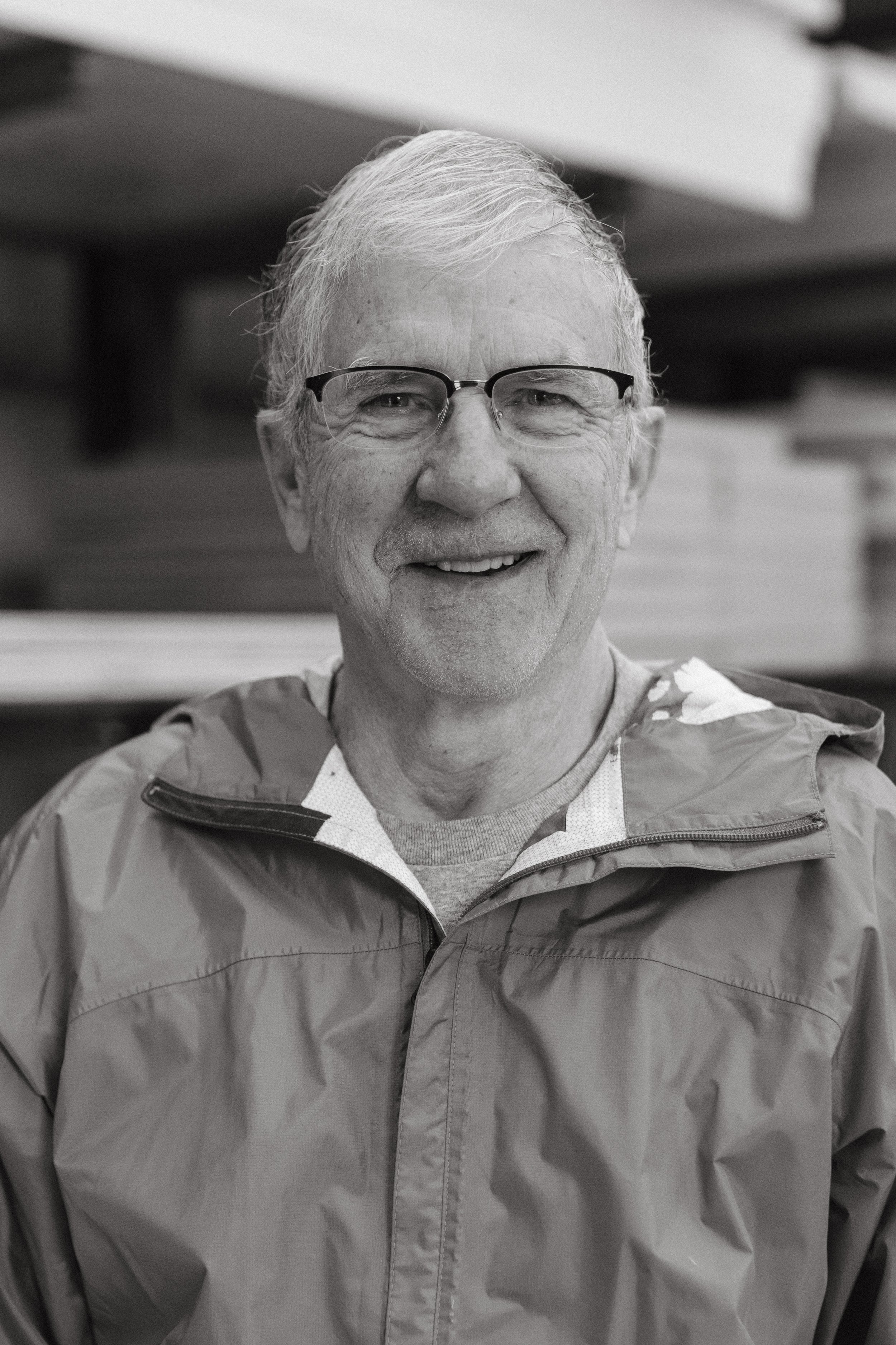 Ted Kingsbury, painter, pictured smiling outside wearing a grey quarter zip