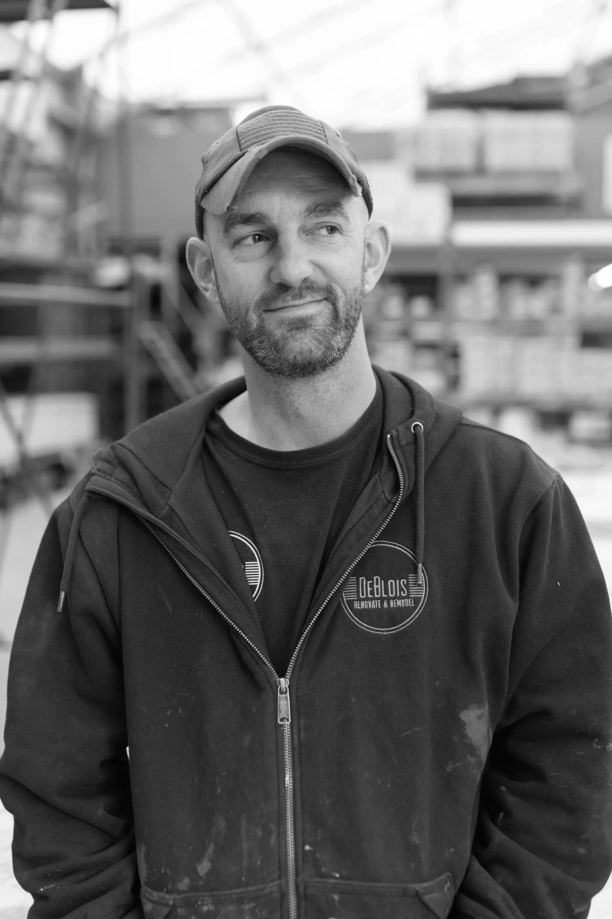 AJ Caiella, carpenter, pictured smiling outside wearing a blue t-shirt