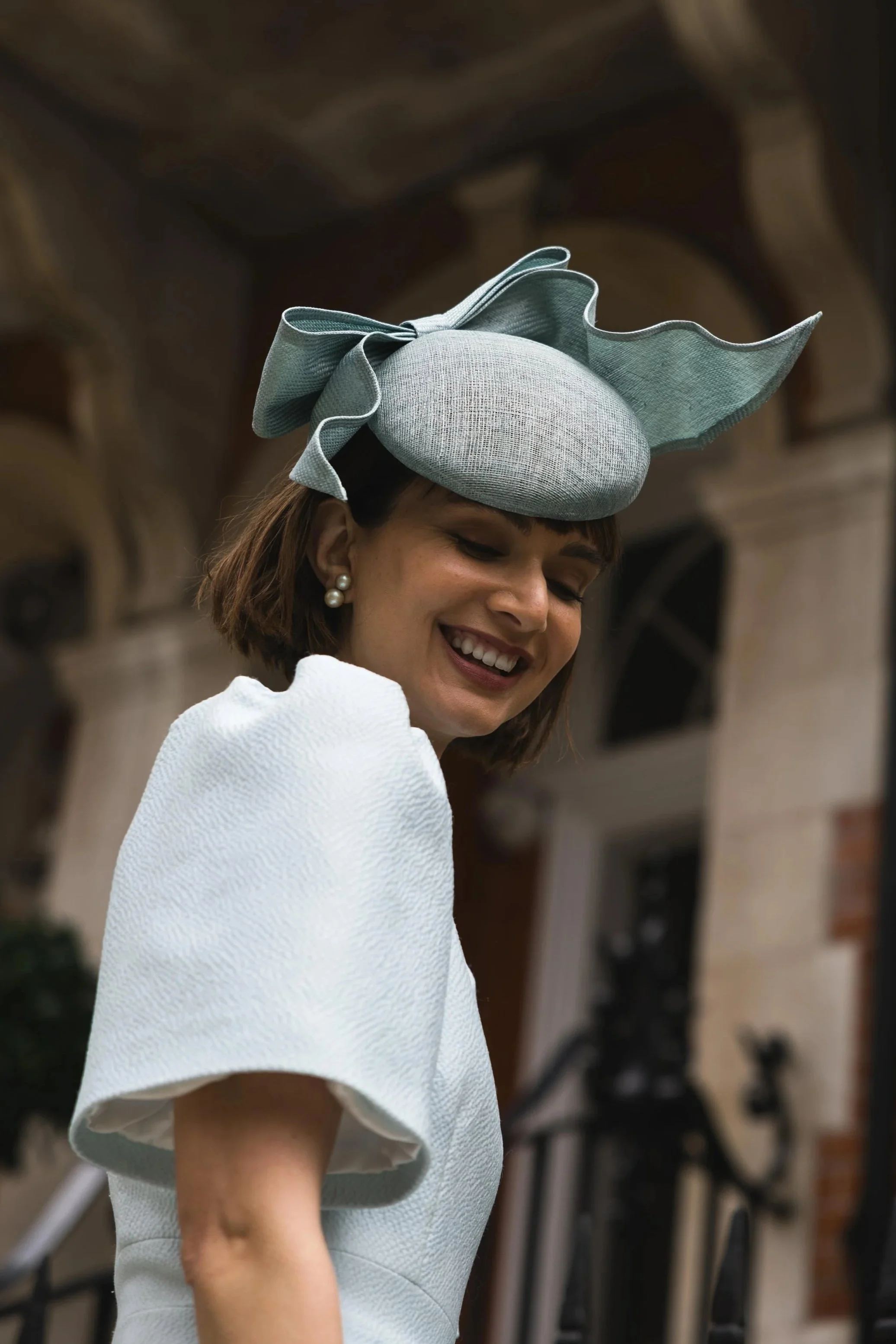 sinamay beret with a parasisal straw sculptural bow