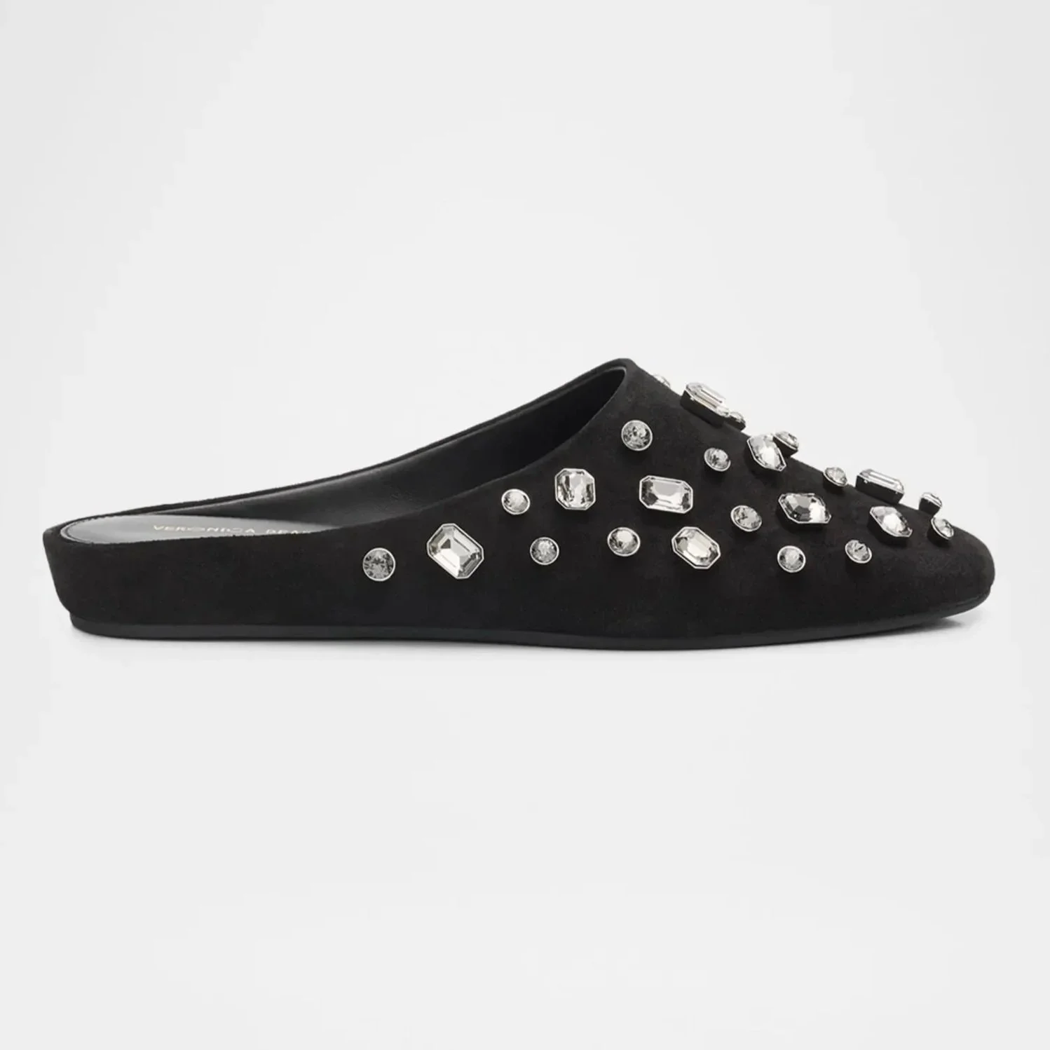 Black slip-on shoe decorated with clear gemstone embellishments on a white background.