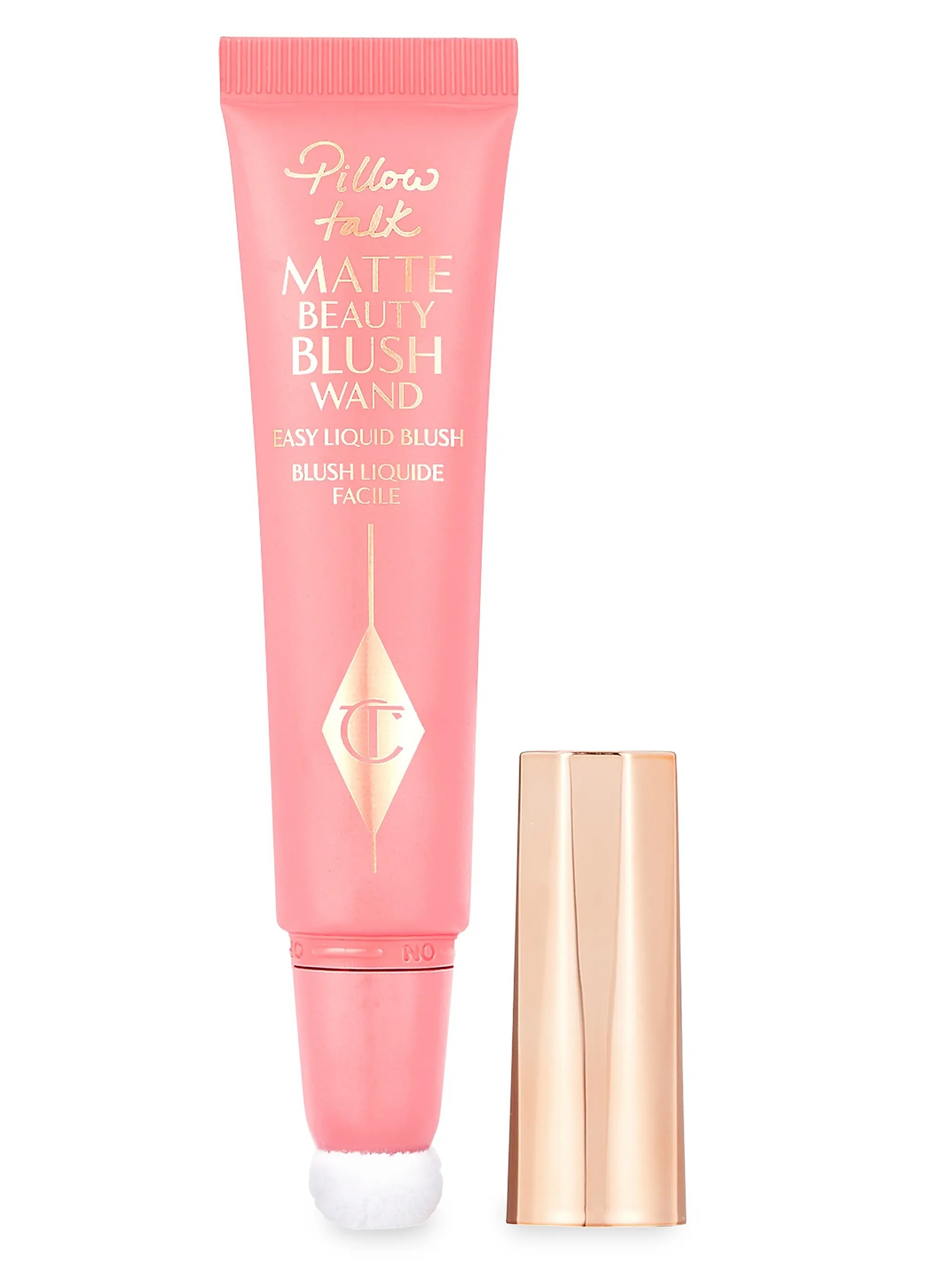Pink tube of Pillow Talk Matte Beauty Blush Wand with a gold cap beside it.