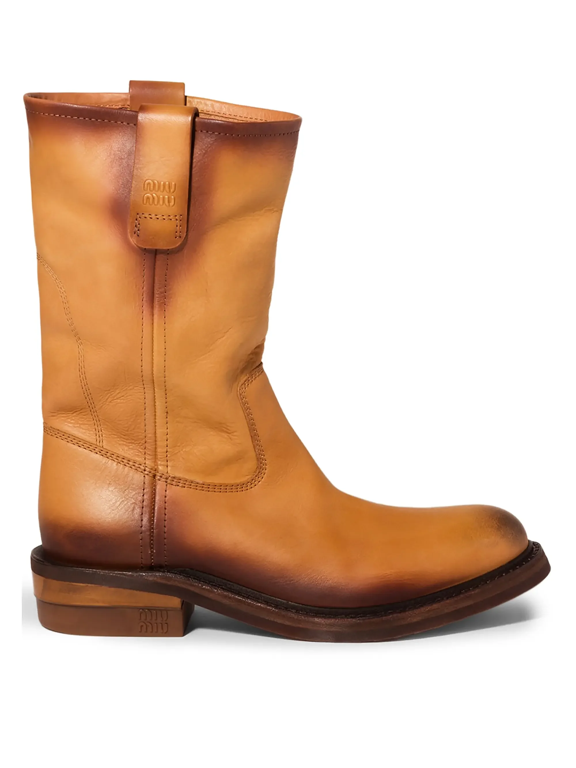 Tan leather boot with a low heel and seam details, isolated on white background.