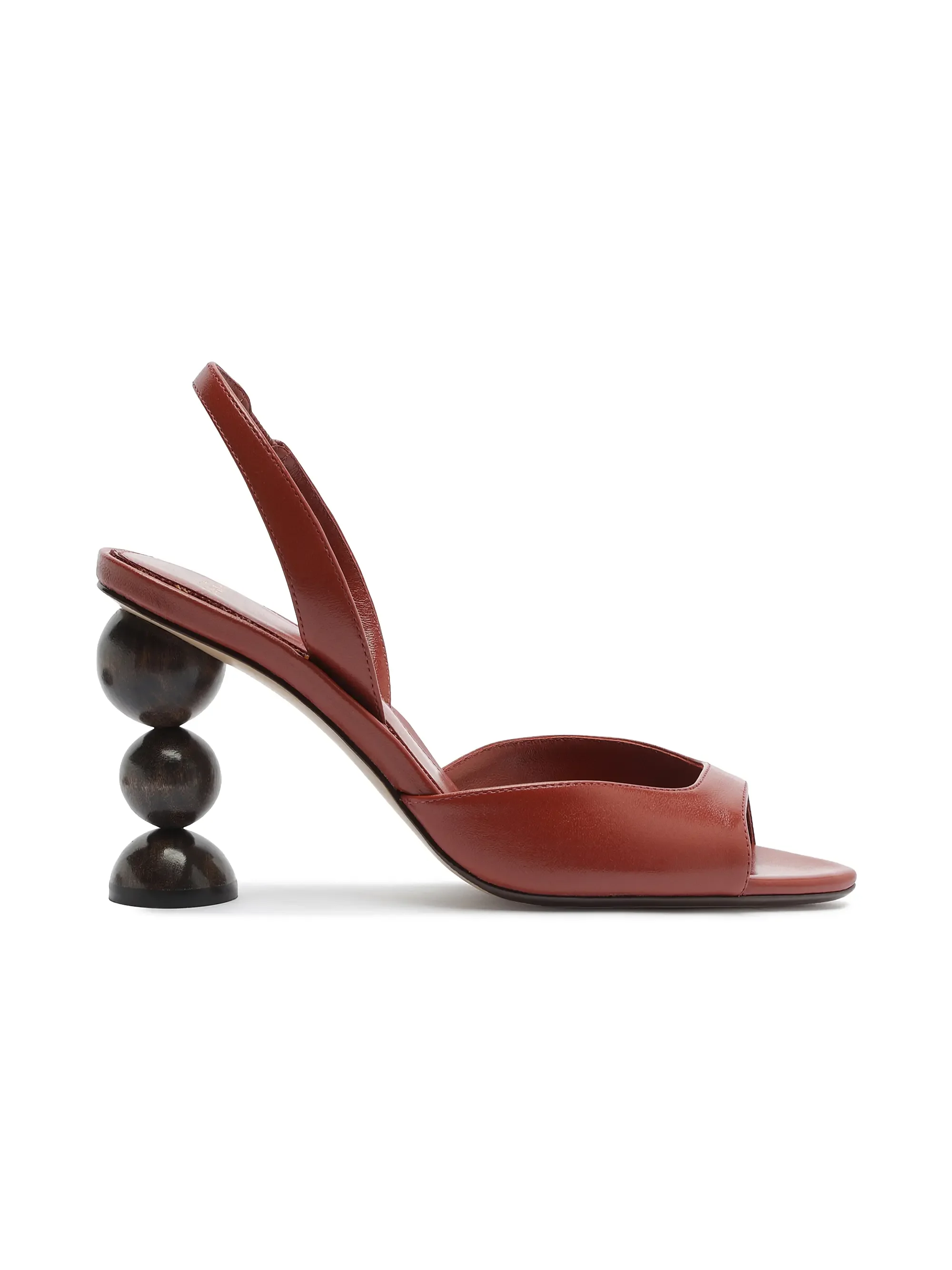 Red high-heeled sandal with a unique black spherical heel design.