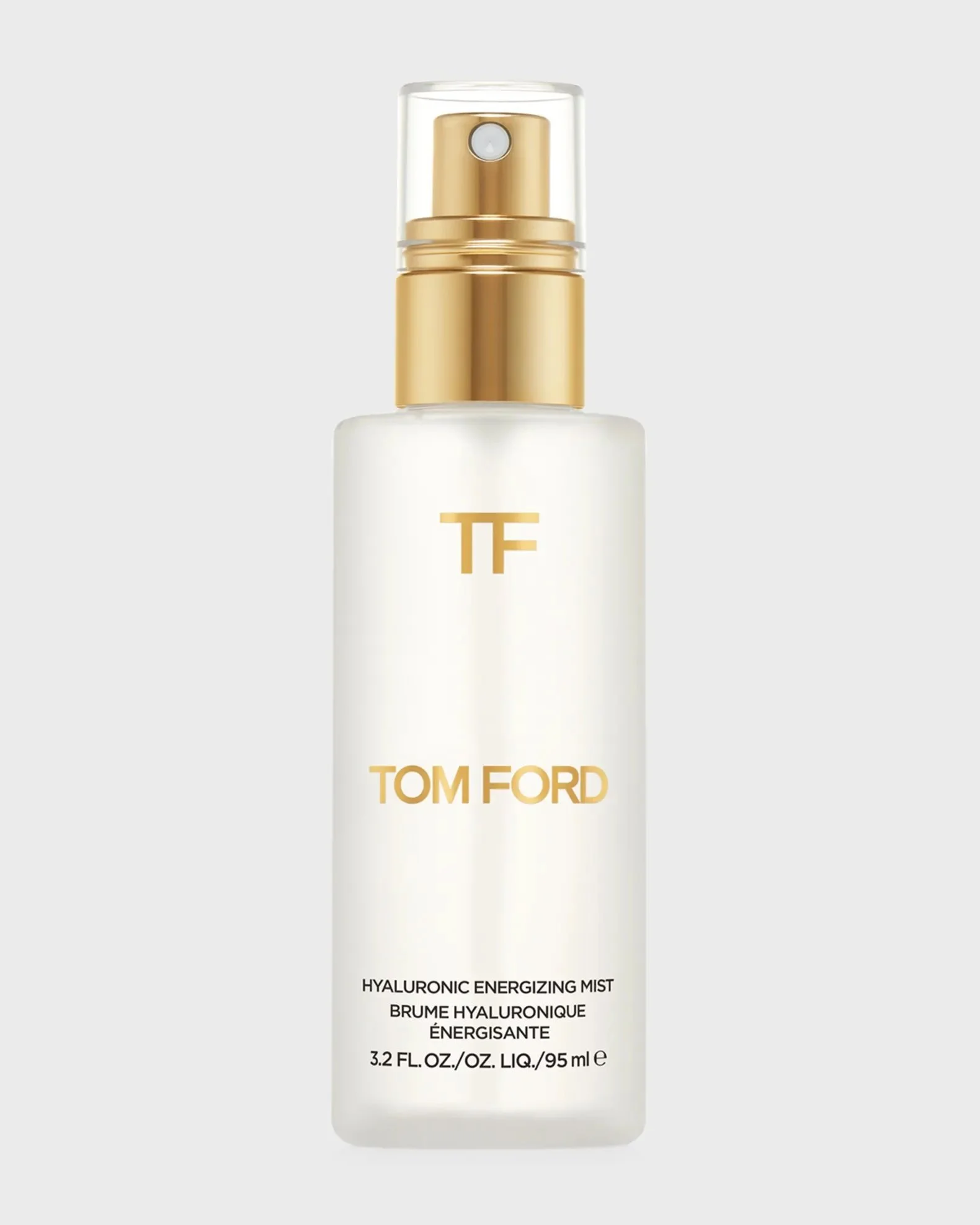 A bottle of Tom Ford Hyaluronic Energizing Mist with a clear cap and gold spray nozzle, white label with gold and black text.