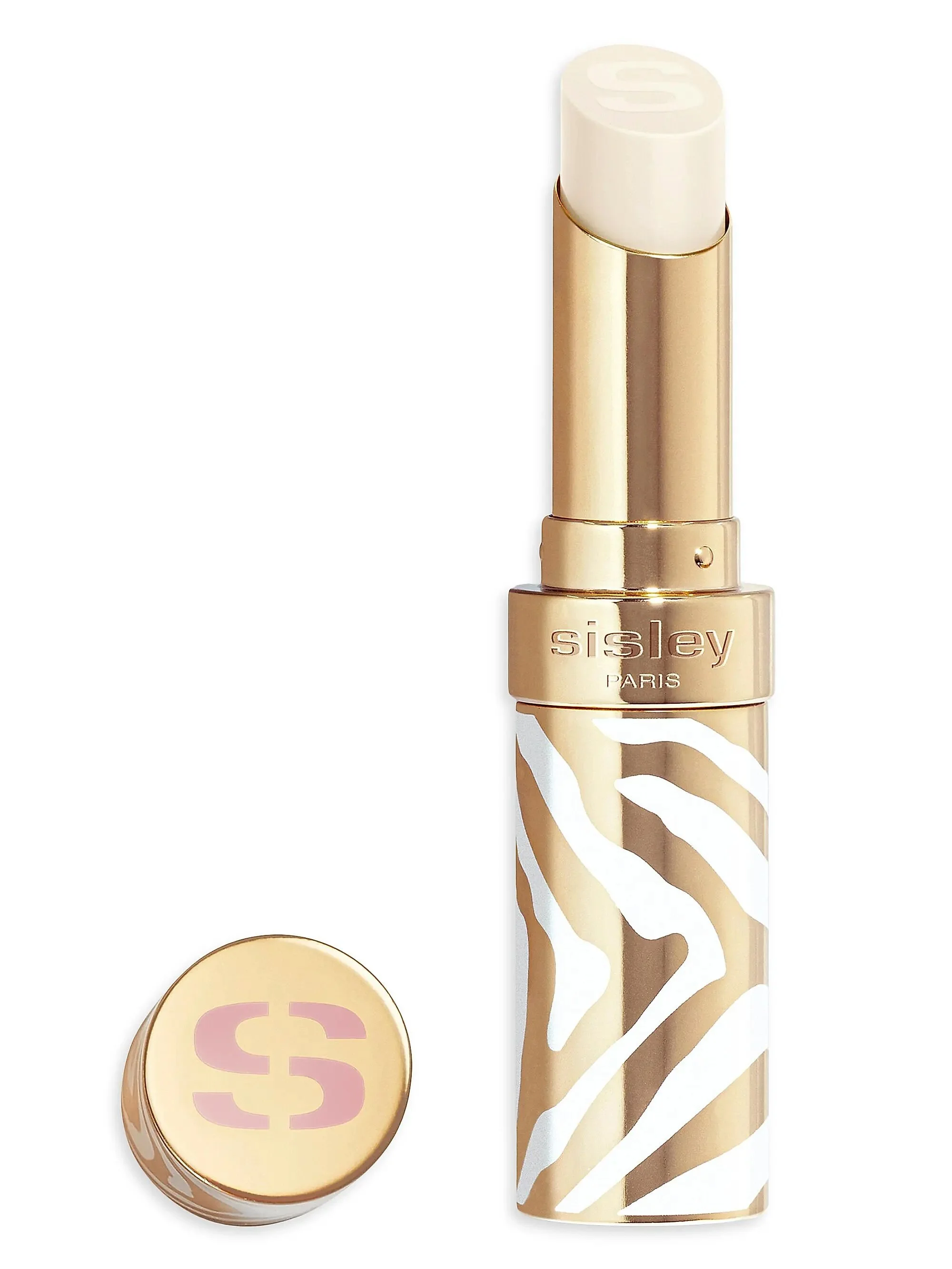 A gold-colored lipstick tube with white zebra stripe pattern, with the cap removed revealing a light-colored lipstick inside. The cap is placed to the left of the tube with a pink 'CS' logo on top.