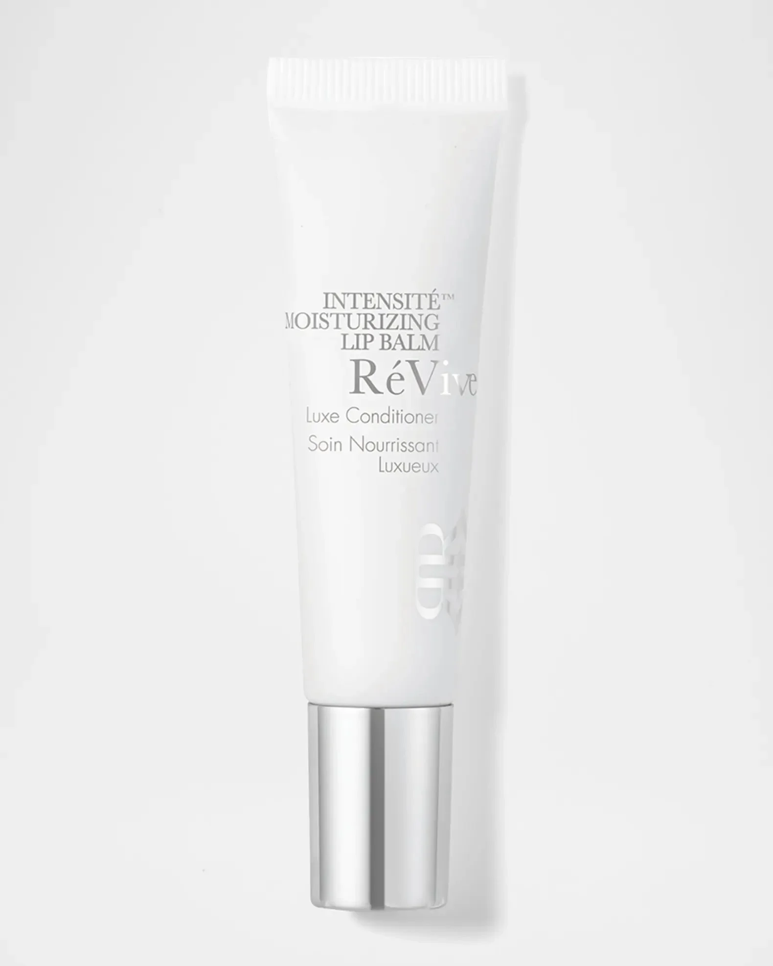 White tube of ReVive Intensity Moisturizing Lip Balm on a white background.