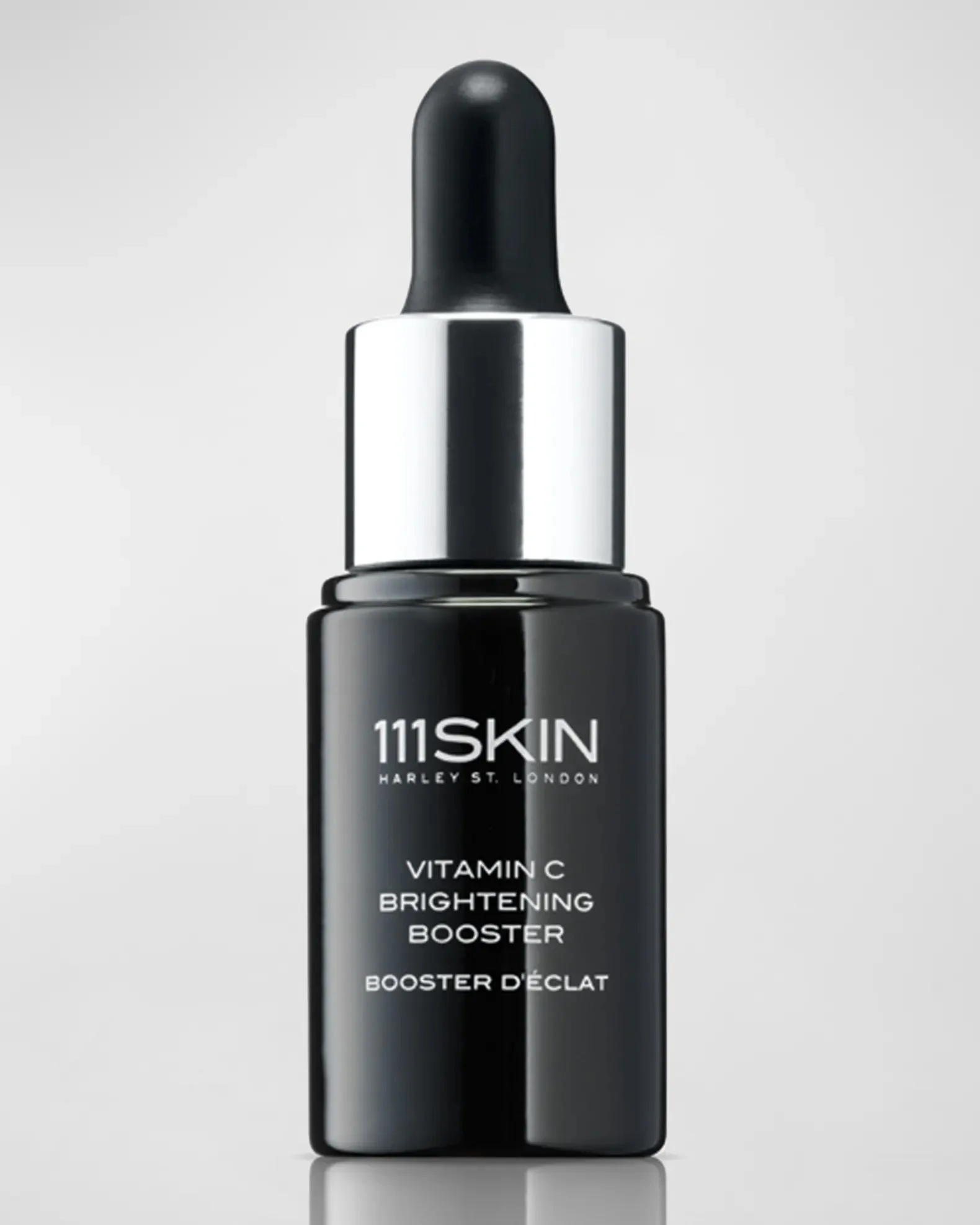 A Black Dropper Bottle labeled 111SKIN Vitamin C Brightening Booster against a light gray background.