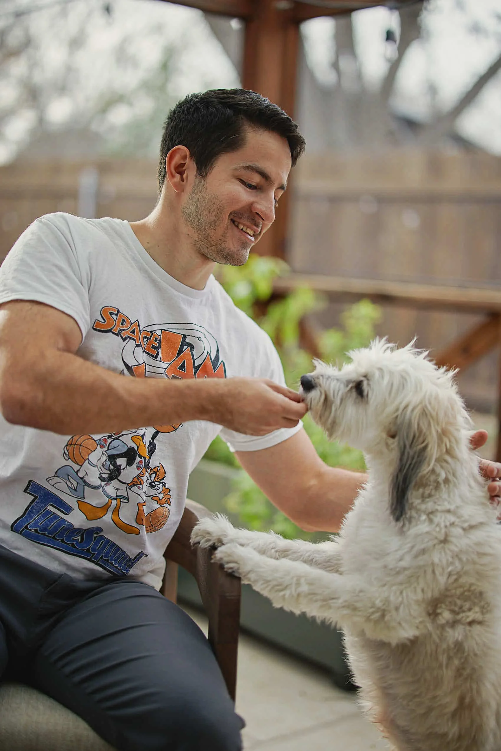 Man holding a gym ball with a confident expression during an Austin online dating photography session
