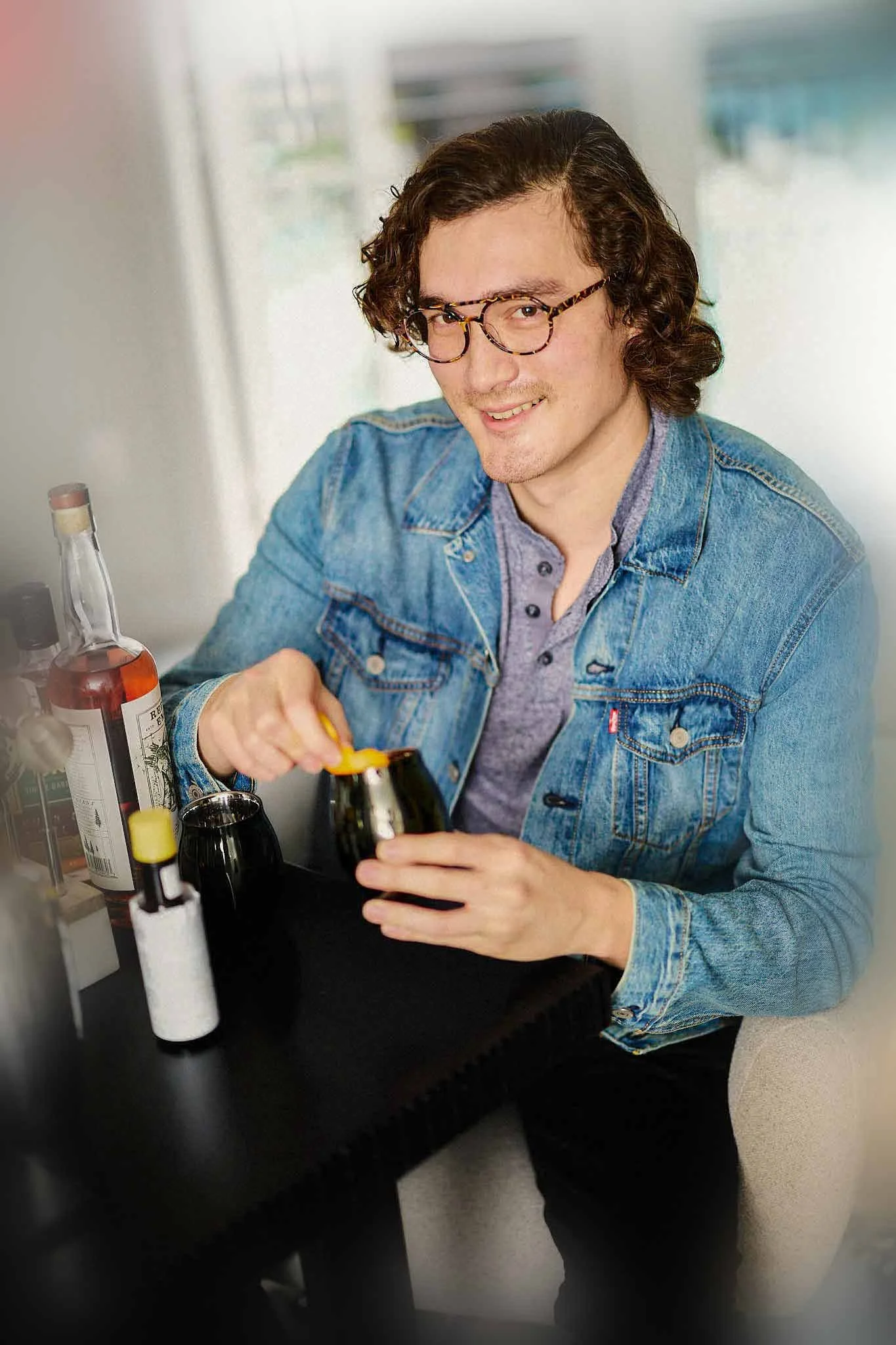 Stylish man crafting an Old Fashioned with fine whisky | Online Dating Photographer Austin