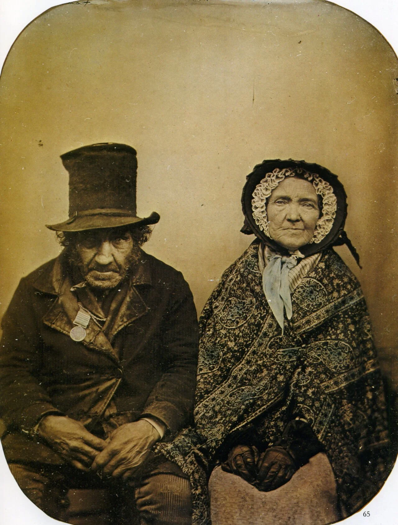 1860s ambrotype of an unnamed British veteran and his wife; the woman is wrapped in a Paisley shawl. From the V&A.