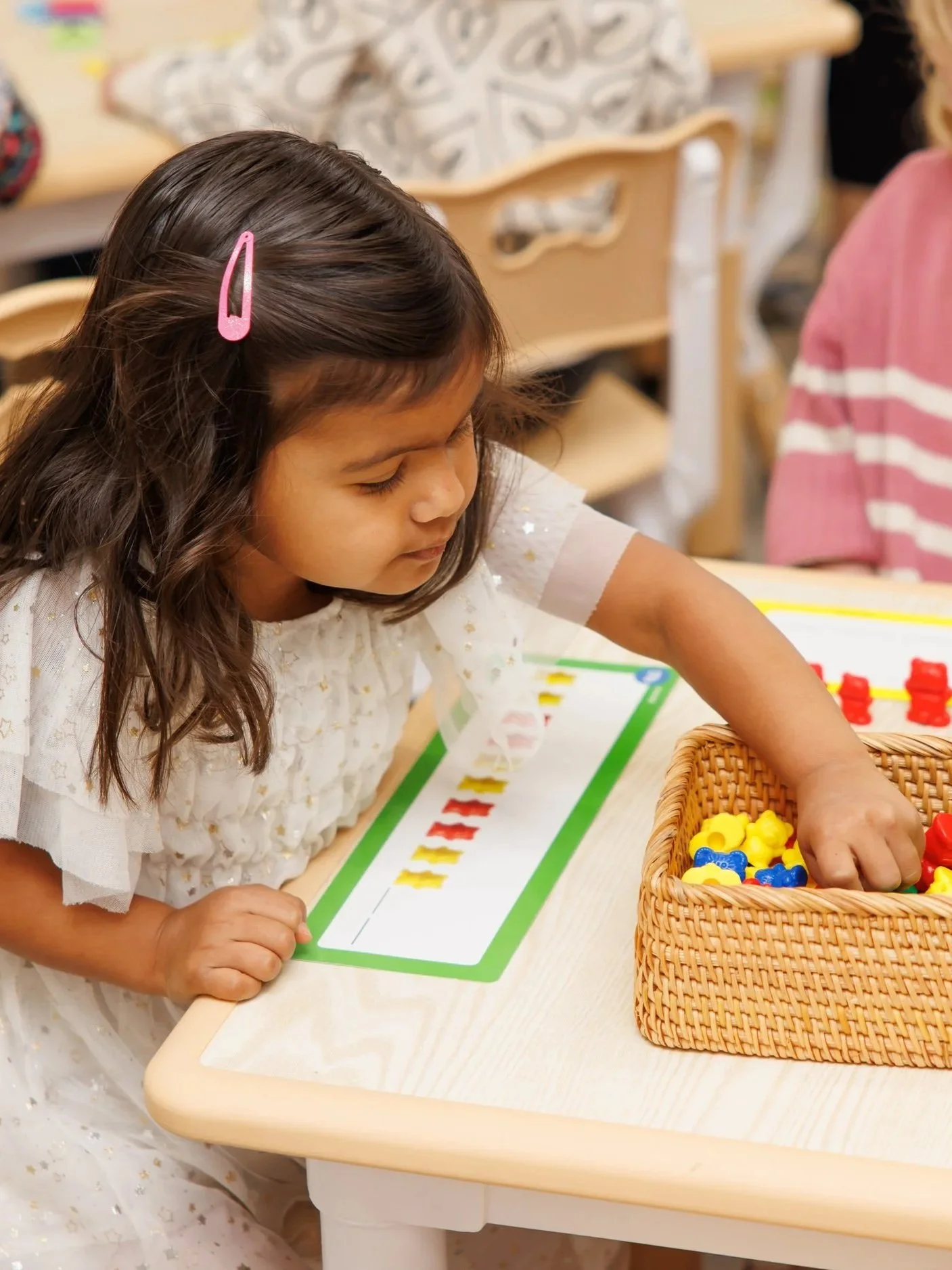 Close-up of an abacus with red, green, and yellow beads on metal rods.